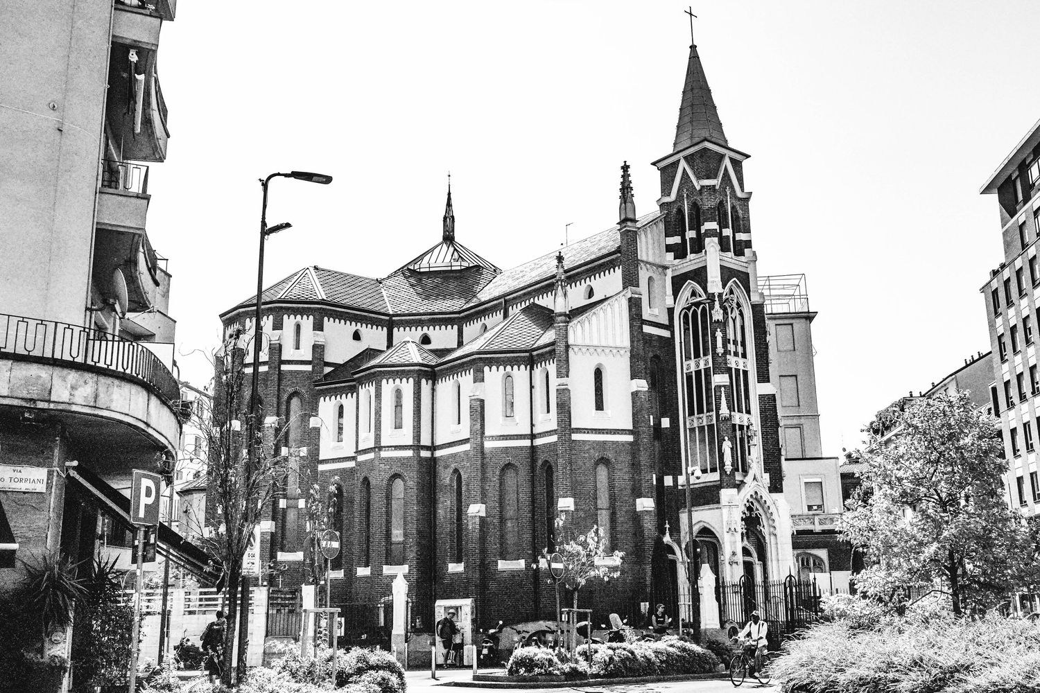 Black and white architectural collage showing historic church spires and buildings in an urban setting.