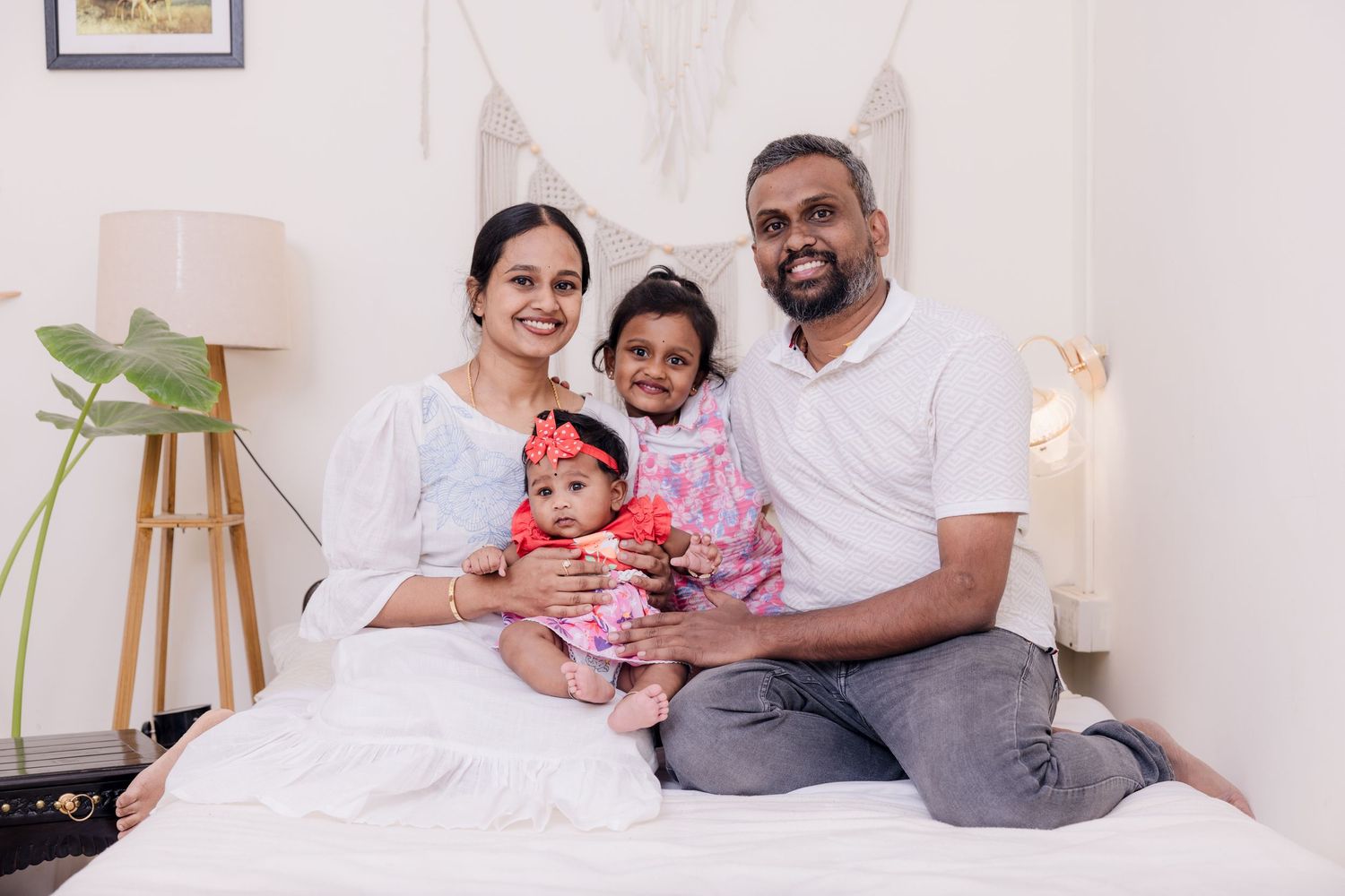 A series of family lifestyle photos showing intimate moments shared on a white bed with natural lighting.