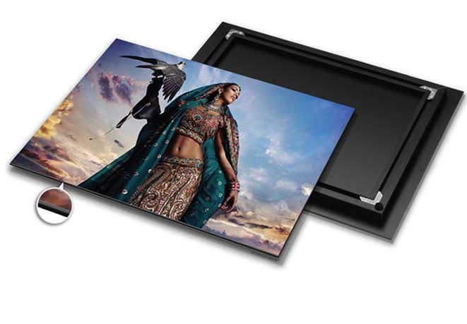 Custom photo prints with black mounting board showing a dramatic desert landscape image against blue sky.