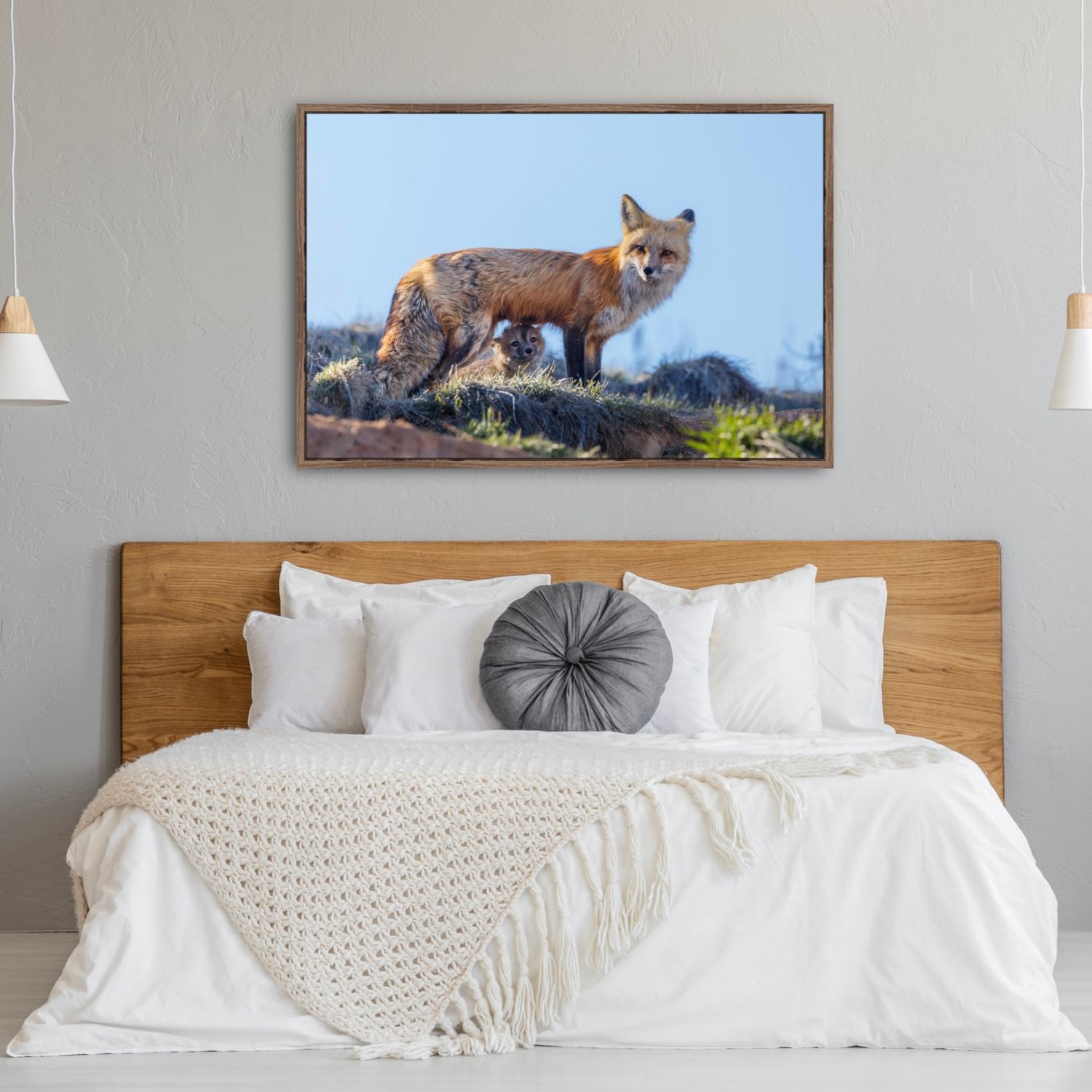 Modern bedroom interior with wooden headboard and wildlife fox artwork displayed above white bedding.