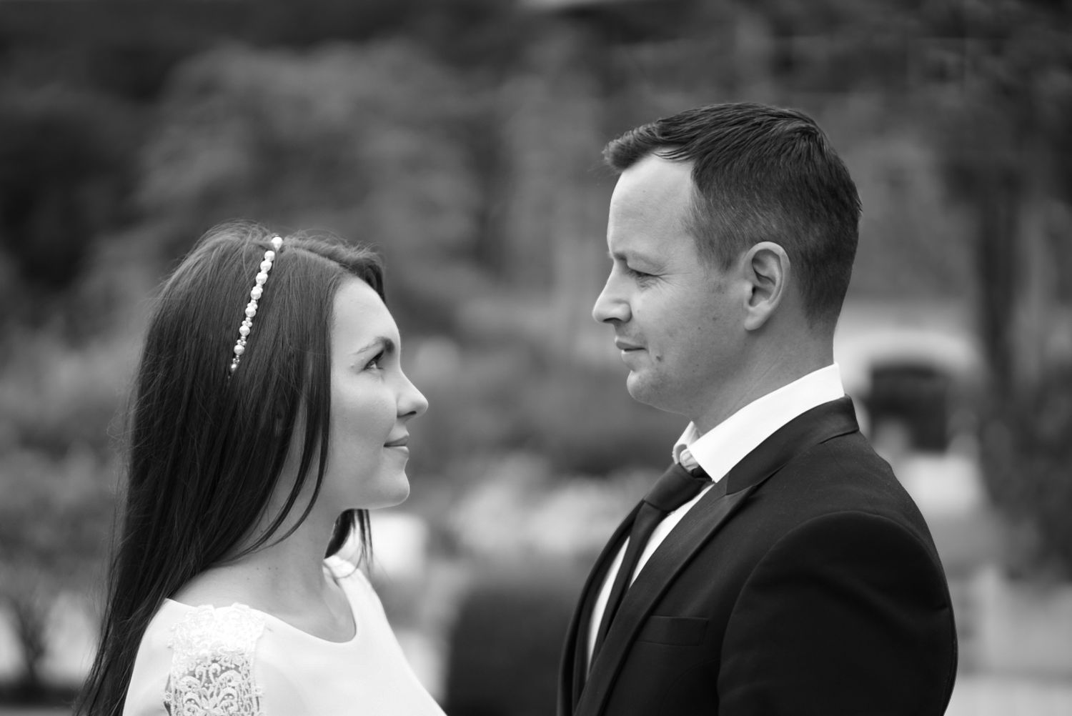 Black and white wedding portraits captured in an intimate outdoor setting.