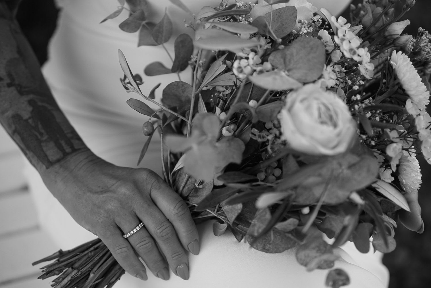 Close-up details of elegant wedding bouquet with mixed flowers.