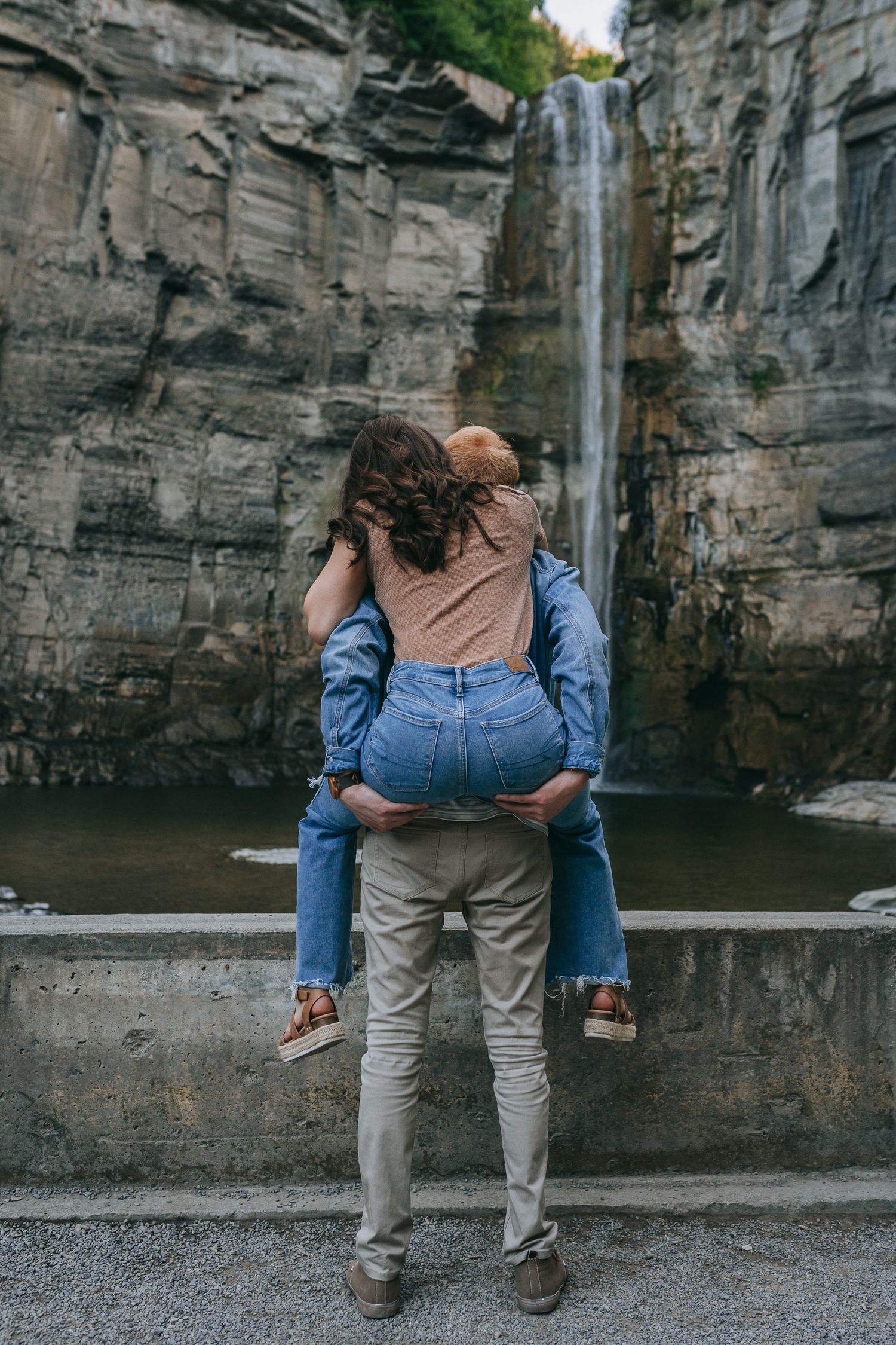 Couple sharing an intimate moment overlooking Taughannock Falls waterfall at Taughannock Falls State Park near Ithaca, NY