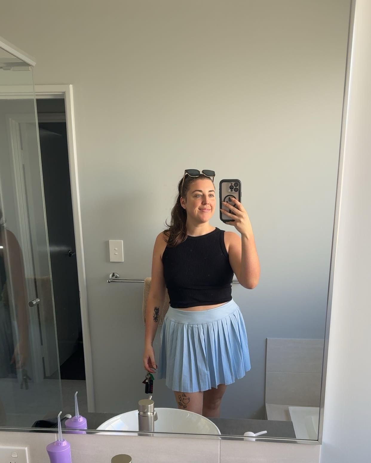 Owner of SeduXion Studio, Paige, shows selfie in blue skirt and black crop top. Mandurah Boudoir Photographer. Perth Boudoir Photographer