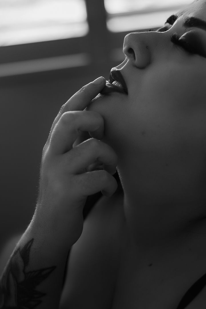 Woman poses for black and white portrait of lips for boudoir photoshoot at SeduXion Boudoir Studio in Mandurah WA