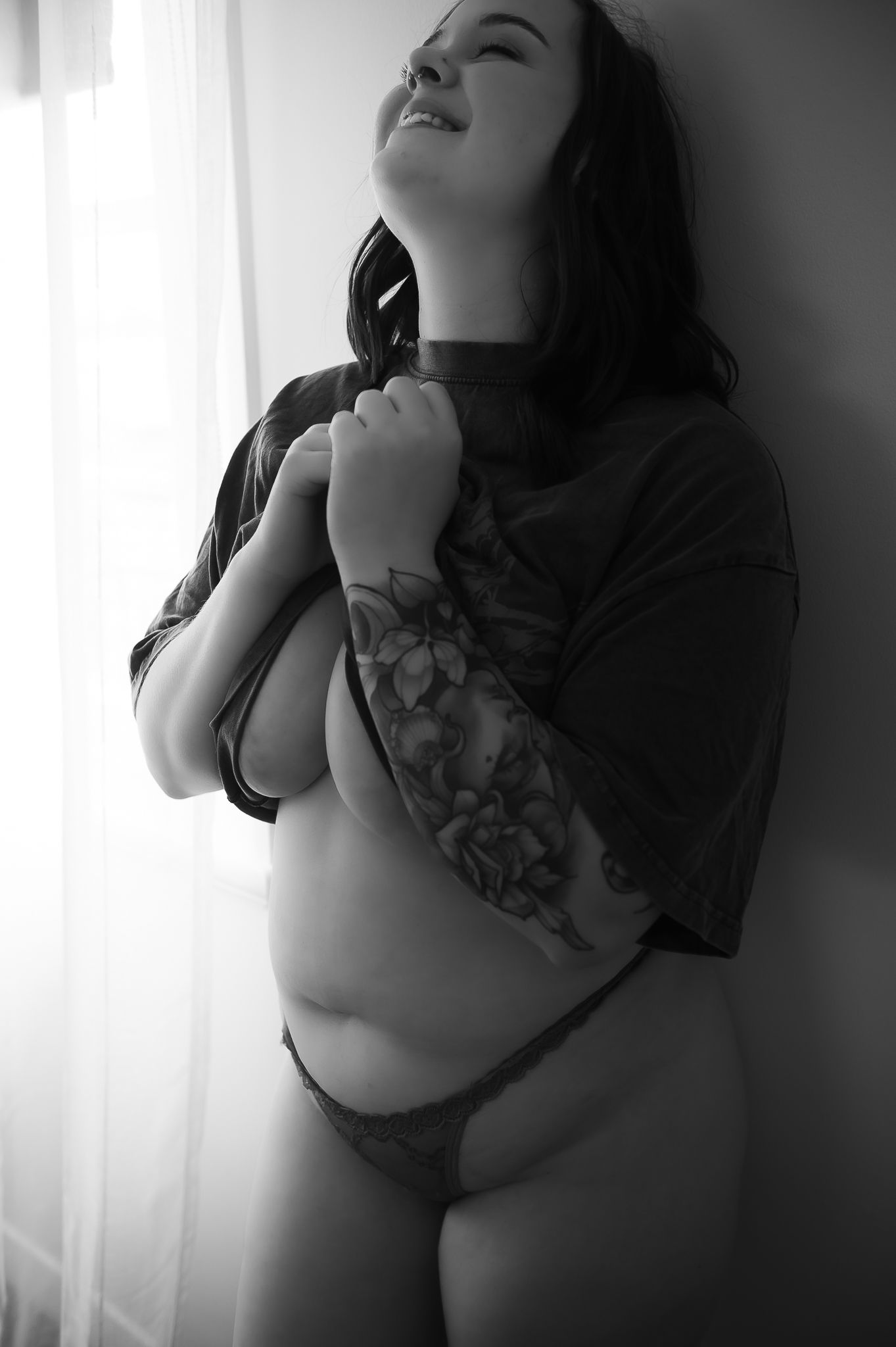 Woman posing in black shirt and red lingerie for boudoir photoshoot at SeduXion Studio in Mandurah WA. Boudoir photographer Mandurah