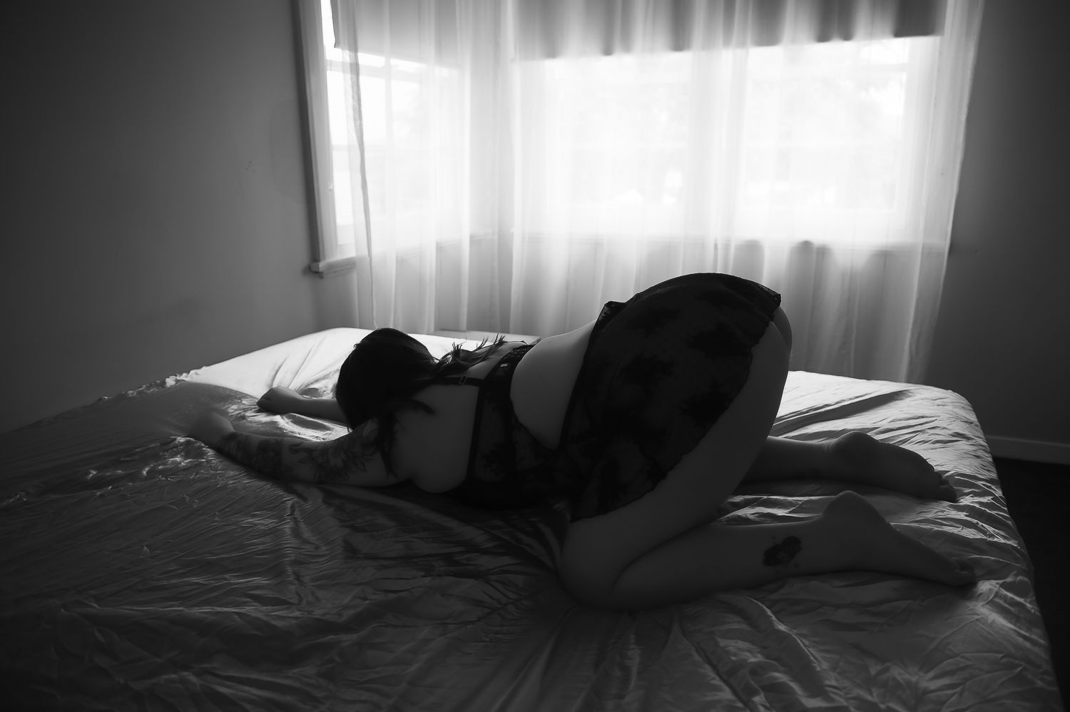 Black and white portrait of woman posing for boudoir photoshoot at SeduXion Studio in Mandurah WA. Boudoir photographer Mandurah