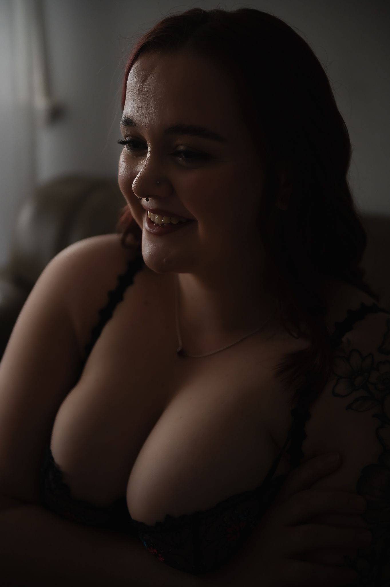 Woman poses for portrait in soft moody lighting for boudoir photoshoot at SeduXion Studio in Mandurah WA. Boudoir photographer Mandurah