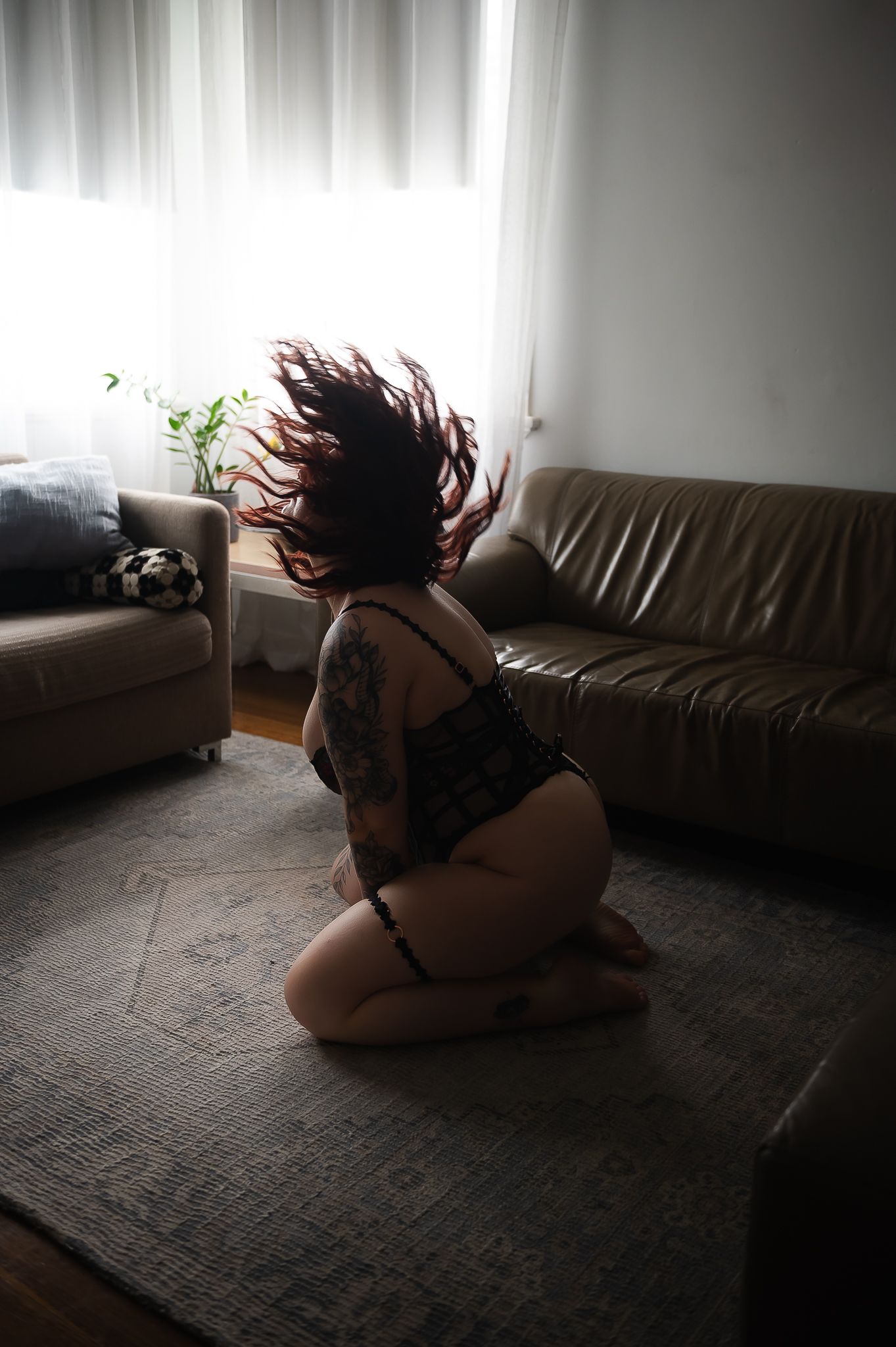 Woman flips hair seductively posing for boudoir photoshoot at SeduXion Studio in Mandurah WA. Boudoir photographer Mandurah