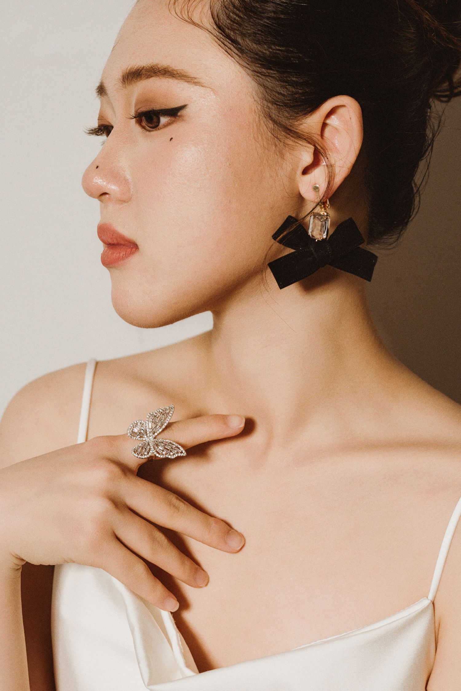 Close-up fashion portraits showcasing delicate jewelry and elegant makeup styling.