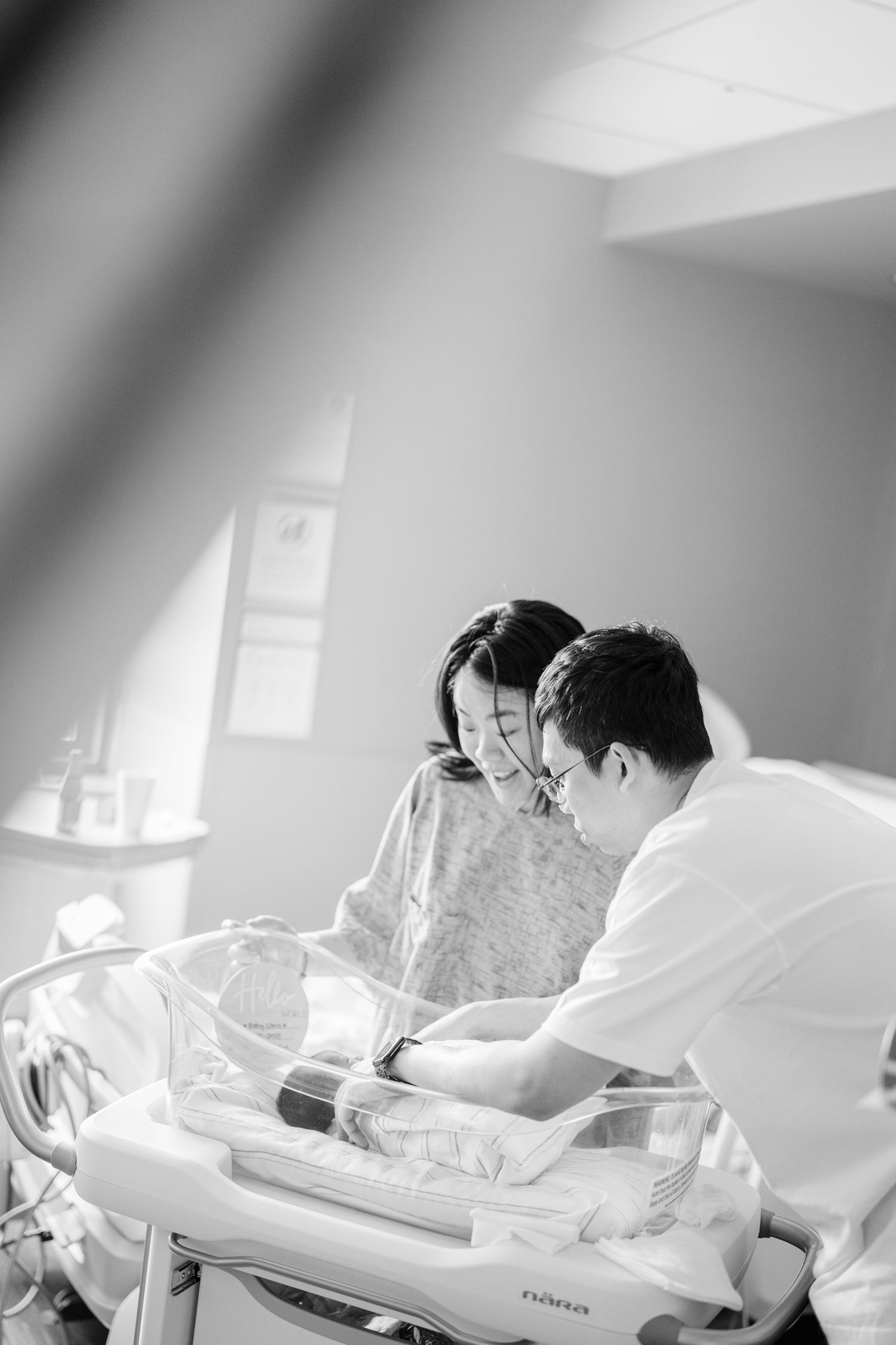 Medical staff examining a newborn baby in a hospital room.