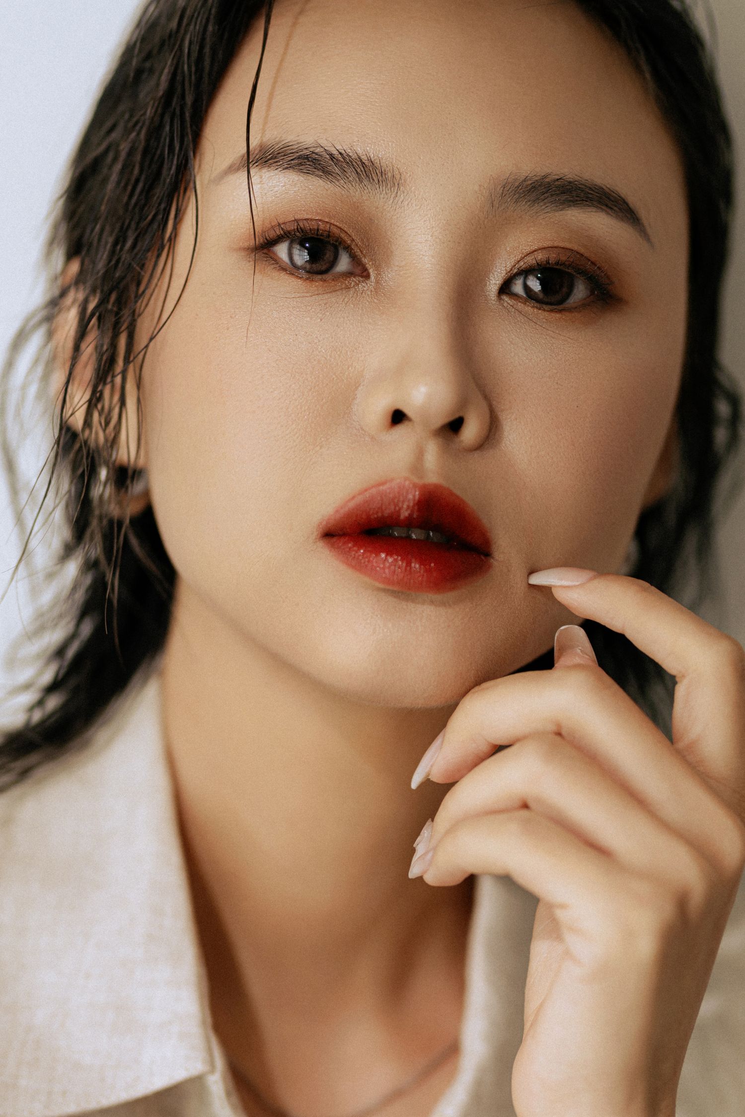 Artistic beauty close-up featuring bold red lips and dramatic eye makeup.