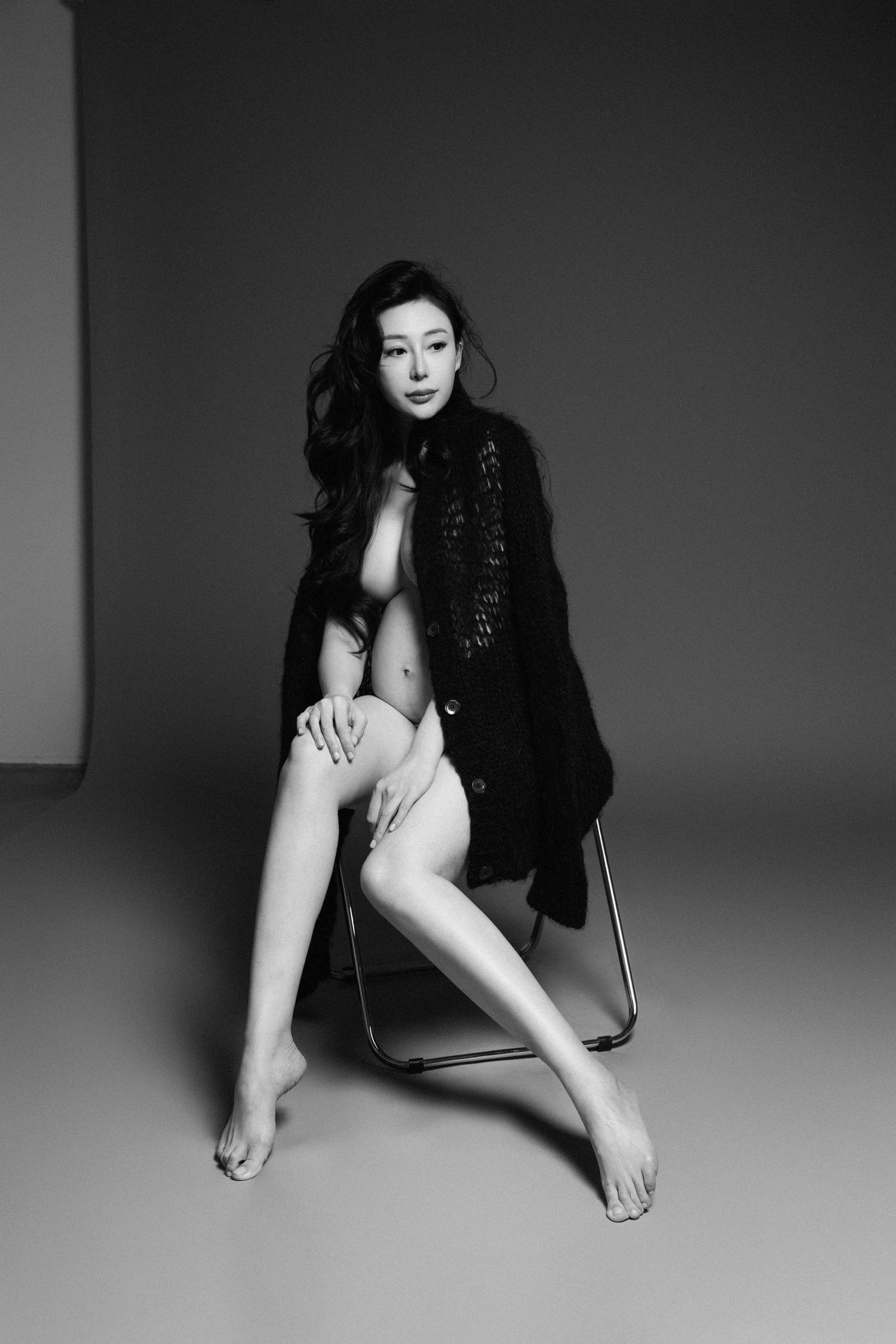 High contrast black and white studio portraits with artistic poses.