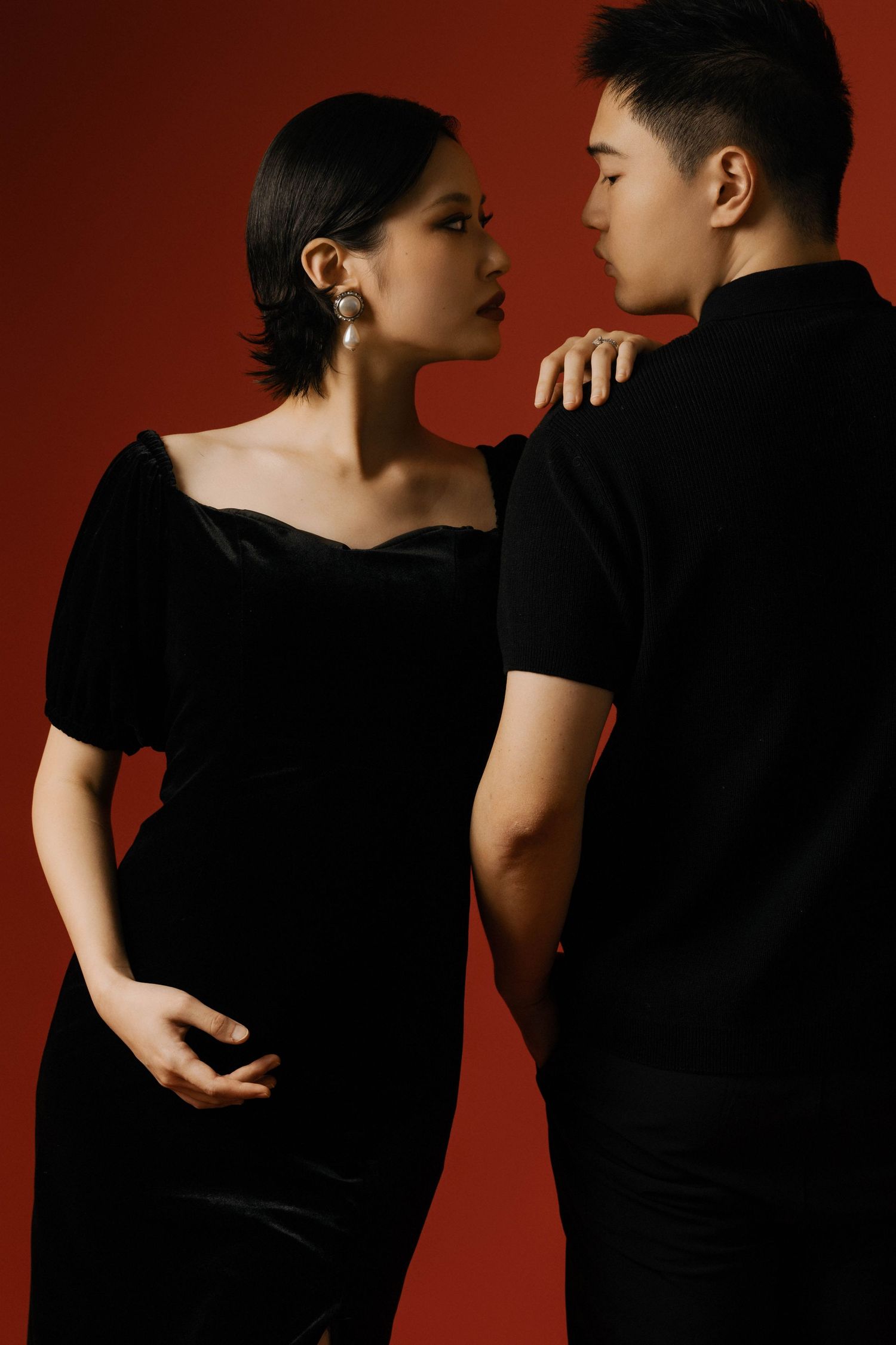 Romantic couple portrait series showing intimate poses in black attire.