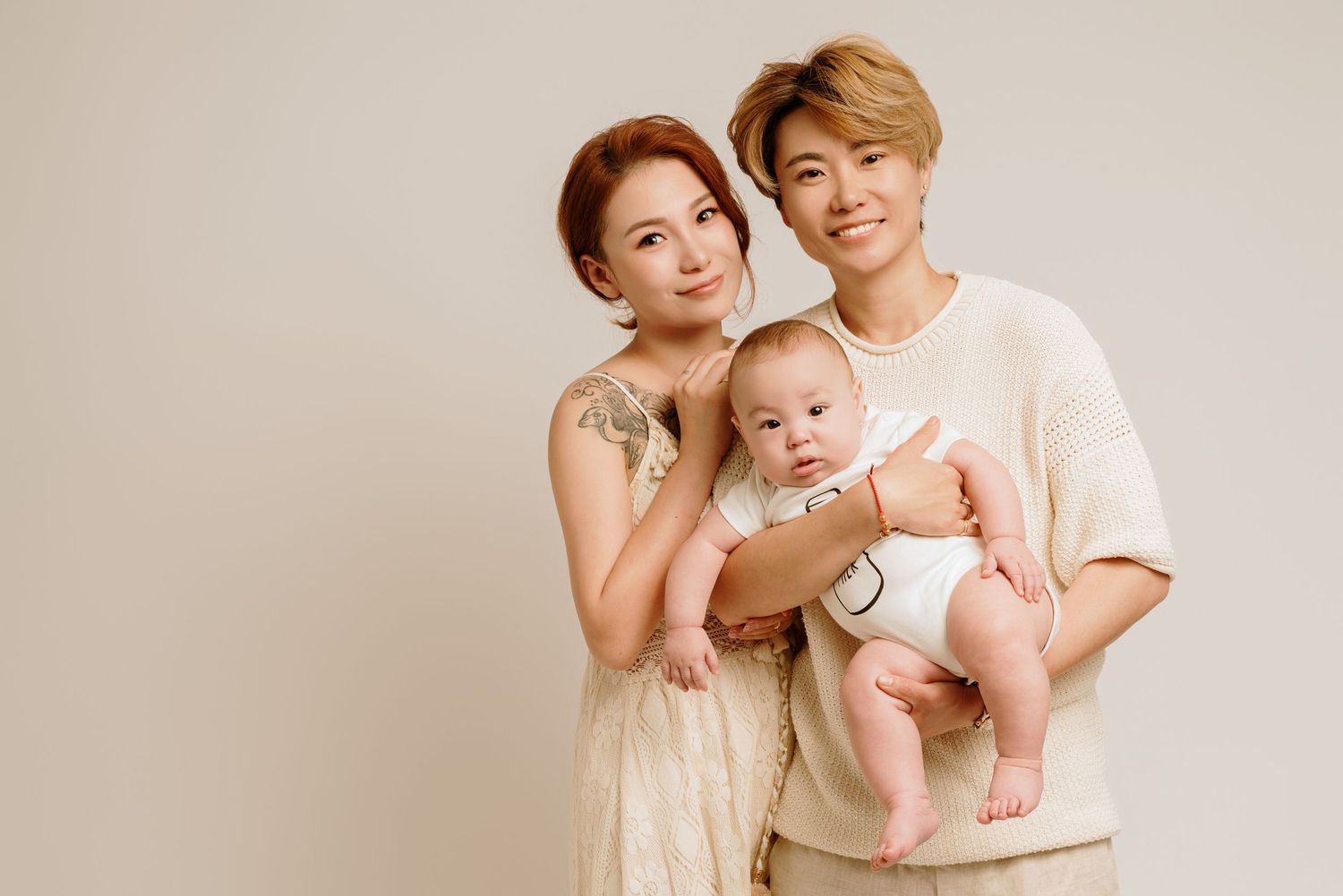Studio portrait in soft neutral colors with lace dress and casual attire.