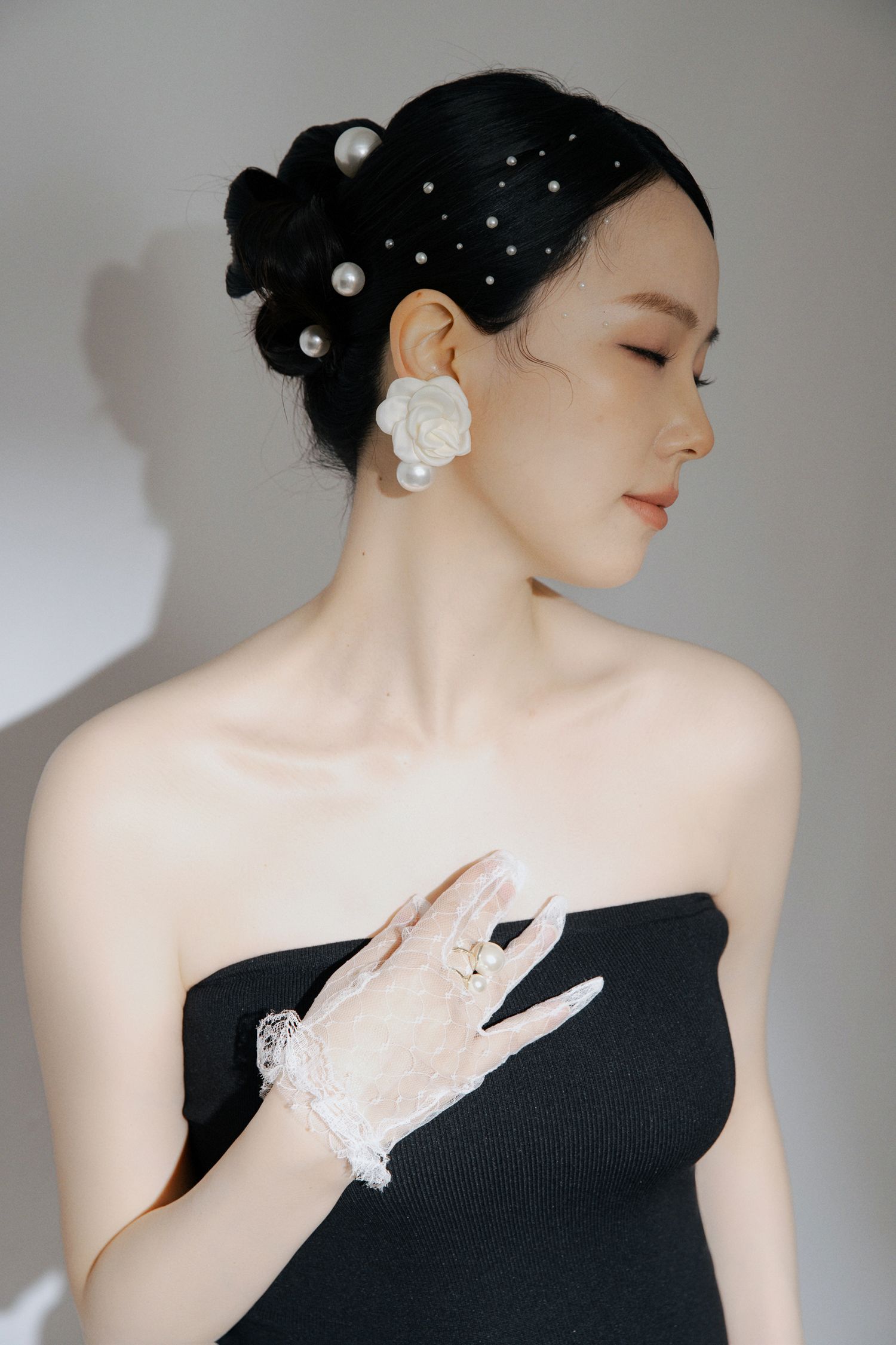 Elegant black and white portraits with pearl accessories and updo hairstyle.