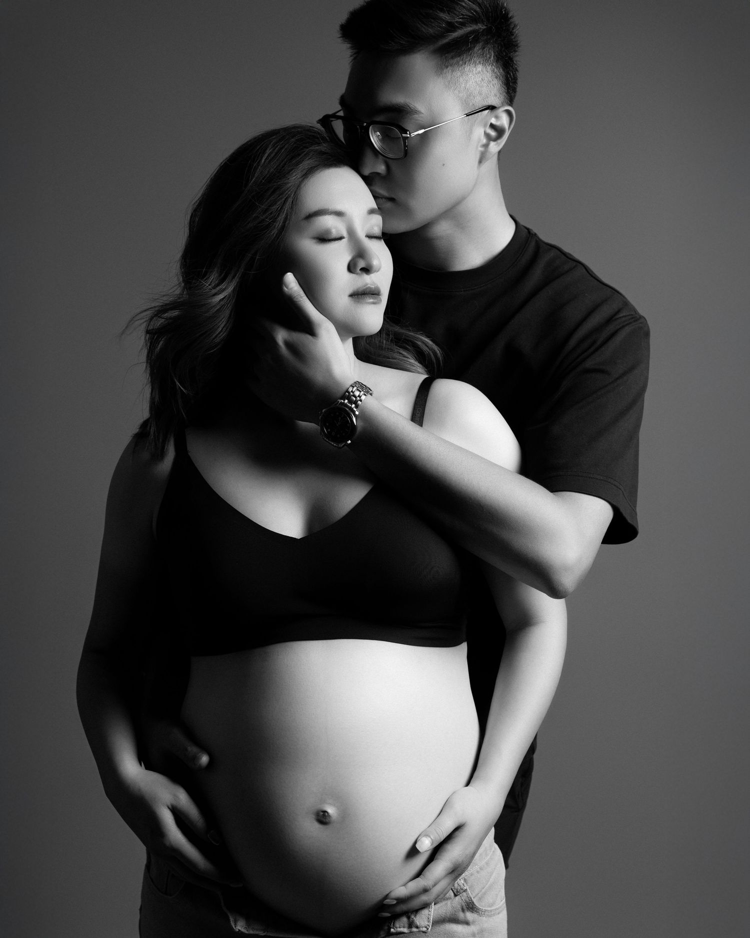 Artistic black and white maternity photo session capturing intimate moments.