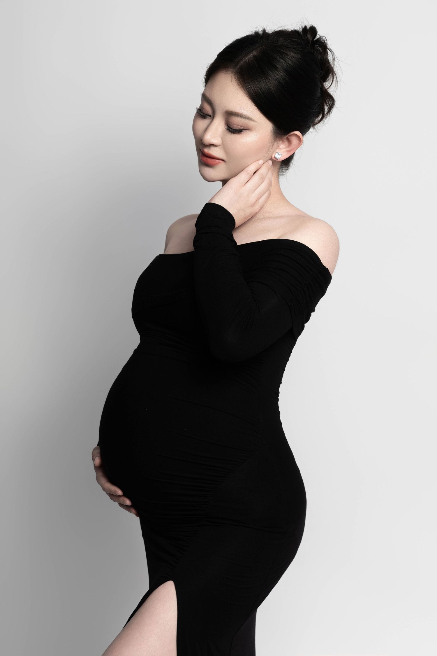 Artistic black and white maternity portraits with dramatic lighting.
