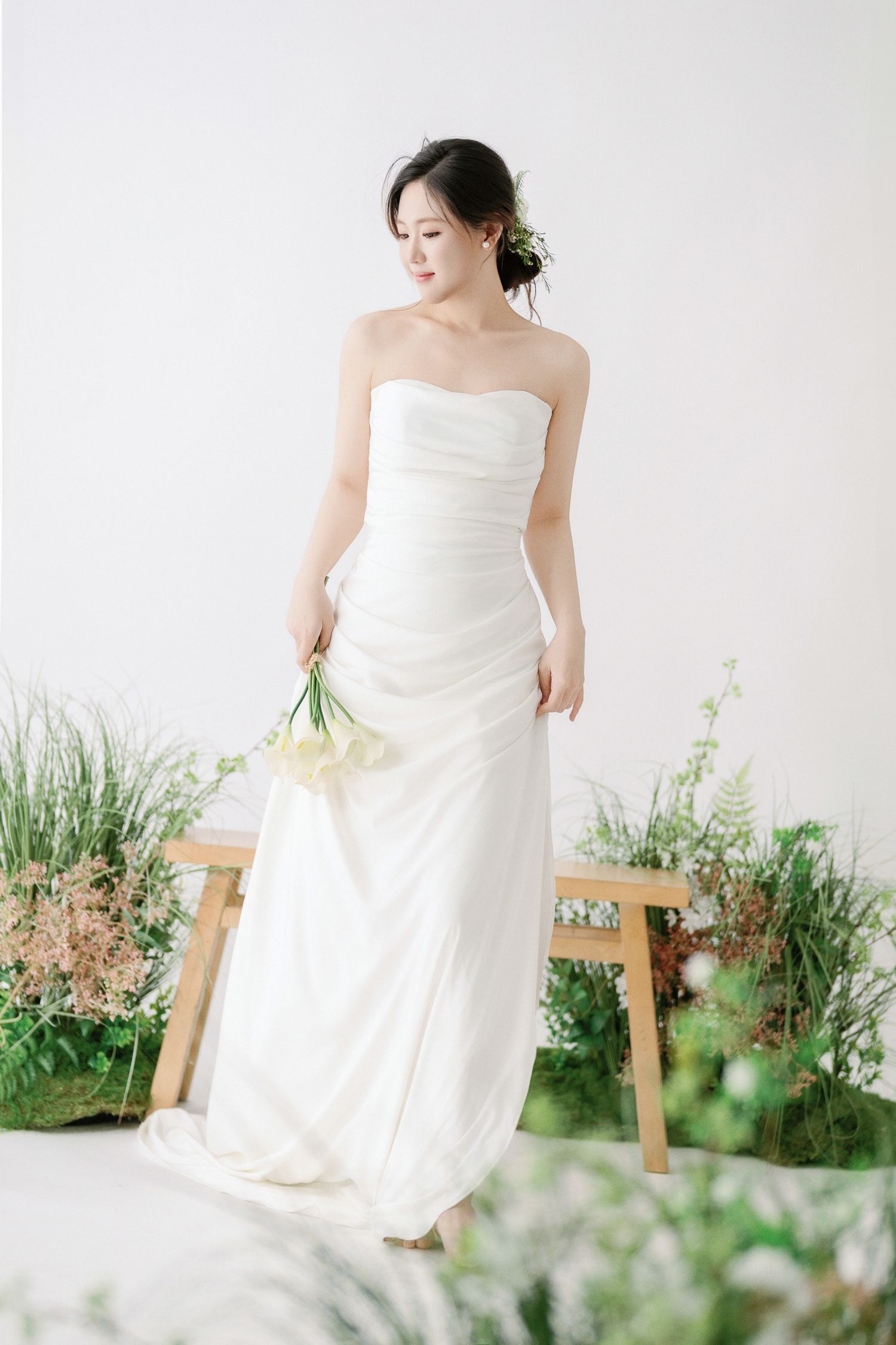 Natural light bridal session with white gown and garden backdrop.