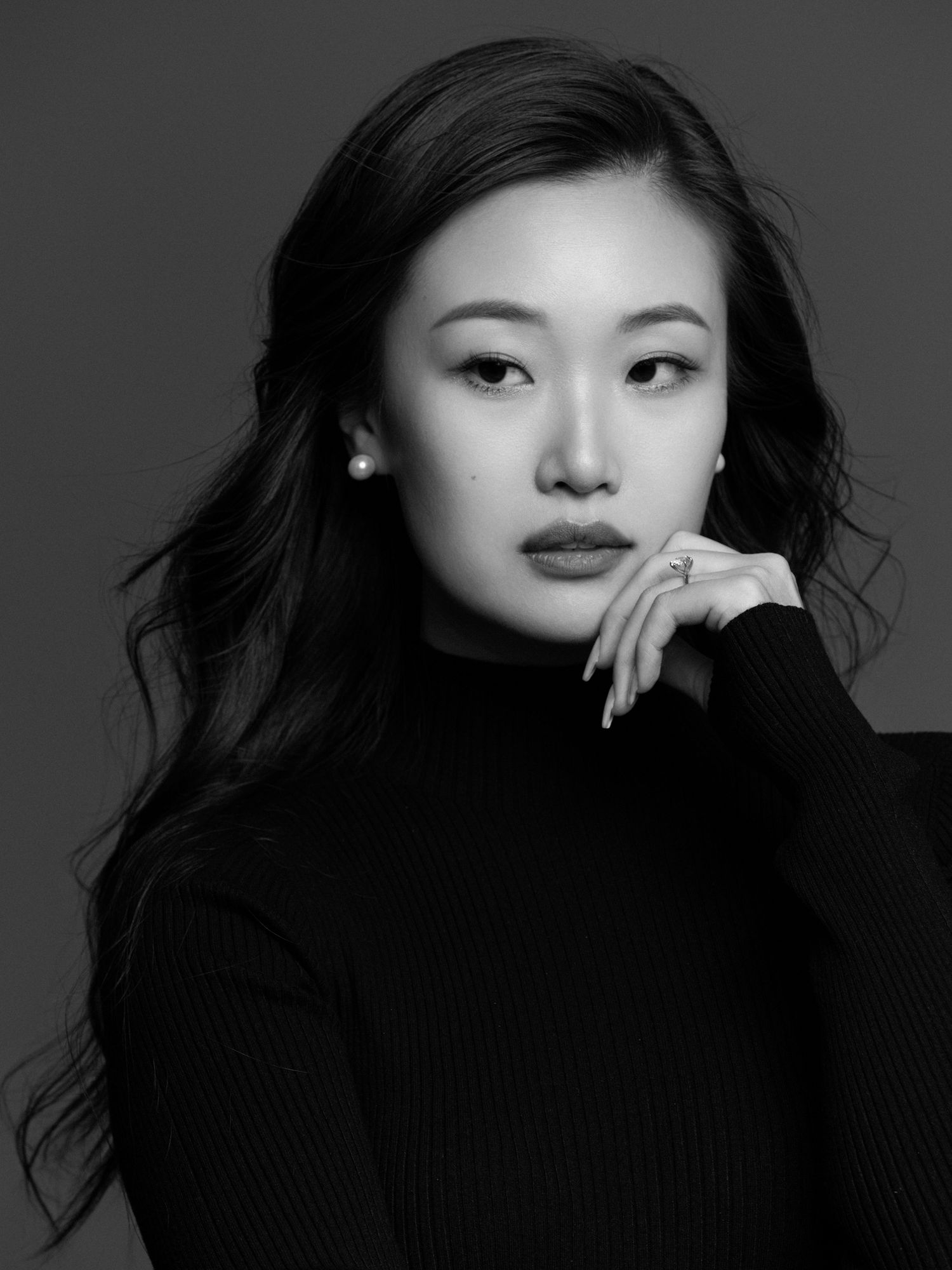 Dramatic close-up portraits in black and white featuring person in dark turtleneck.