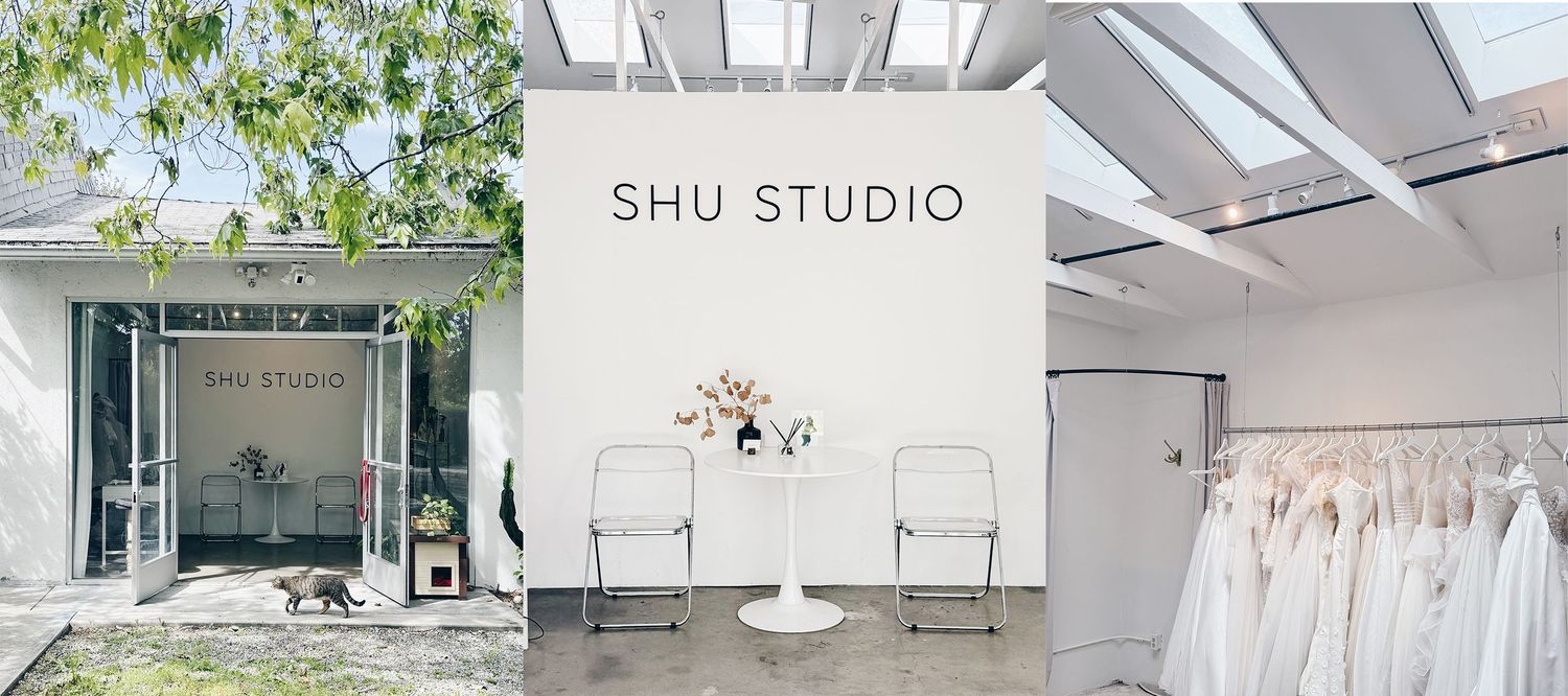 Bright photography studio space with green plants visible through large windows.