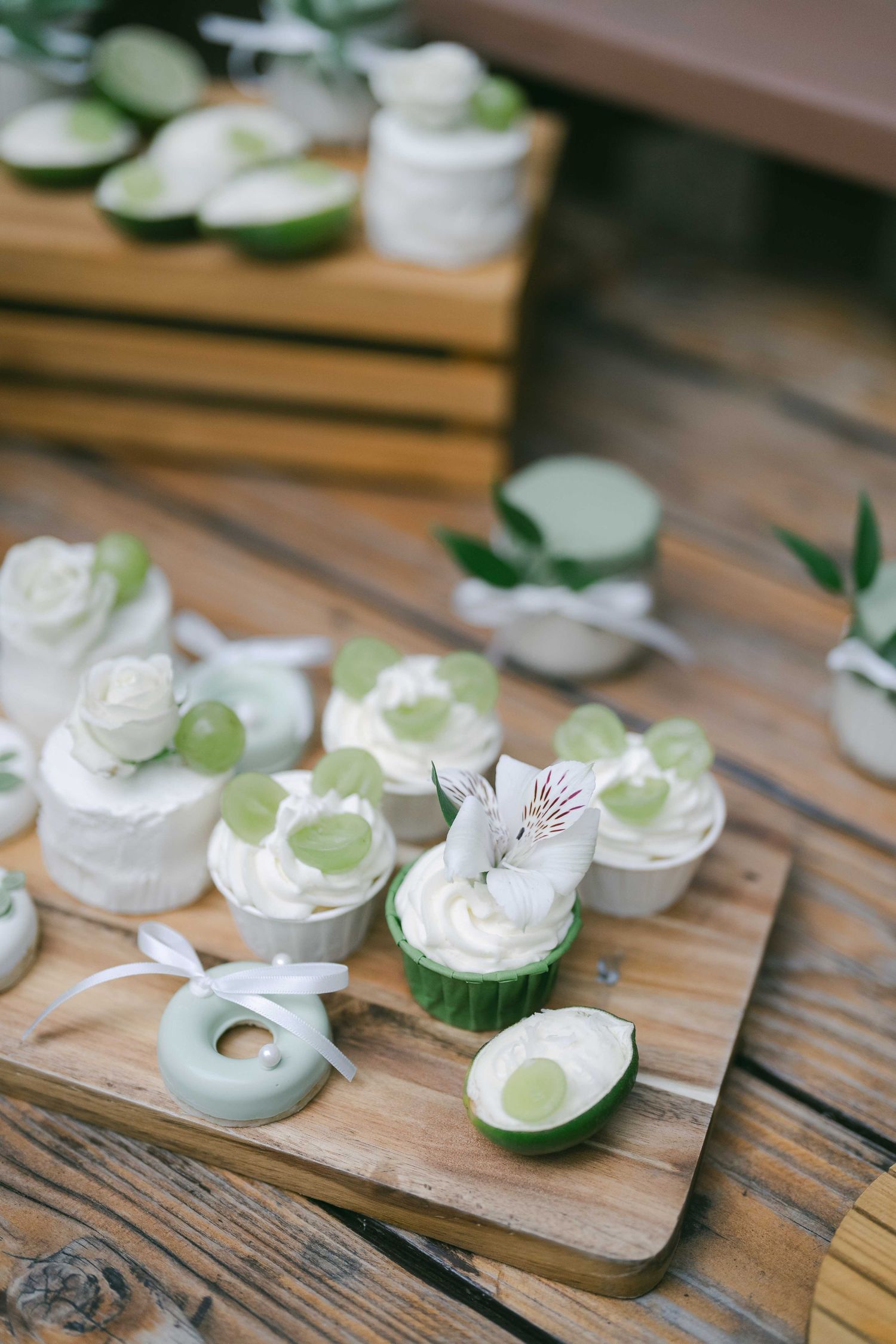 White floral decorative elements arranged on a rustic wooden surface.