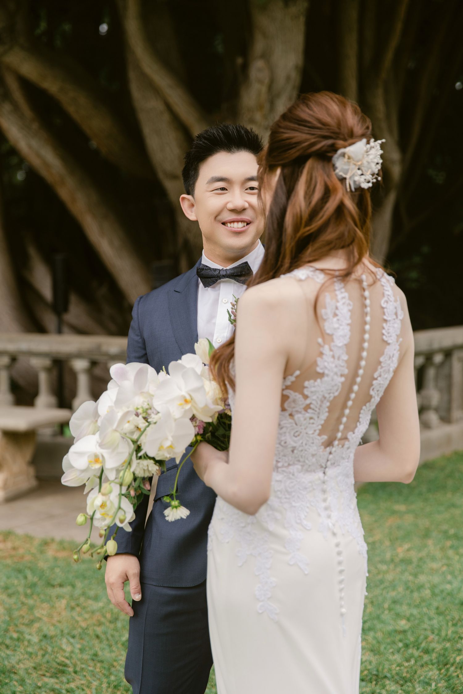 A joyful wedding moment captured in a sunlit garden setting.