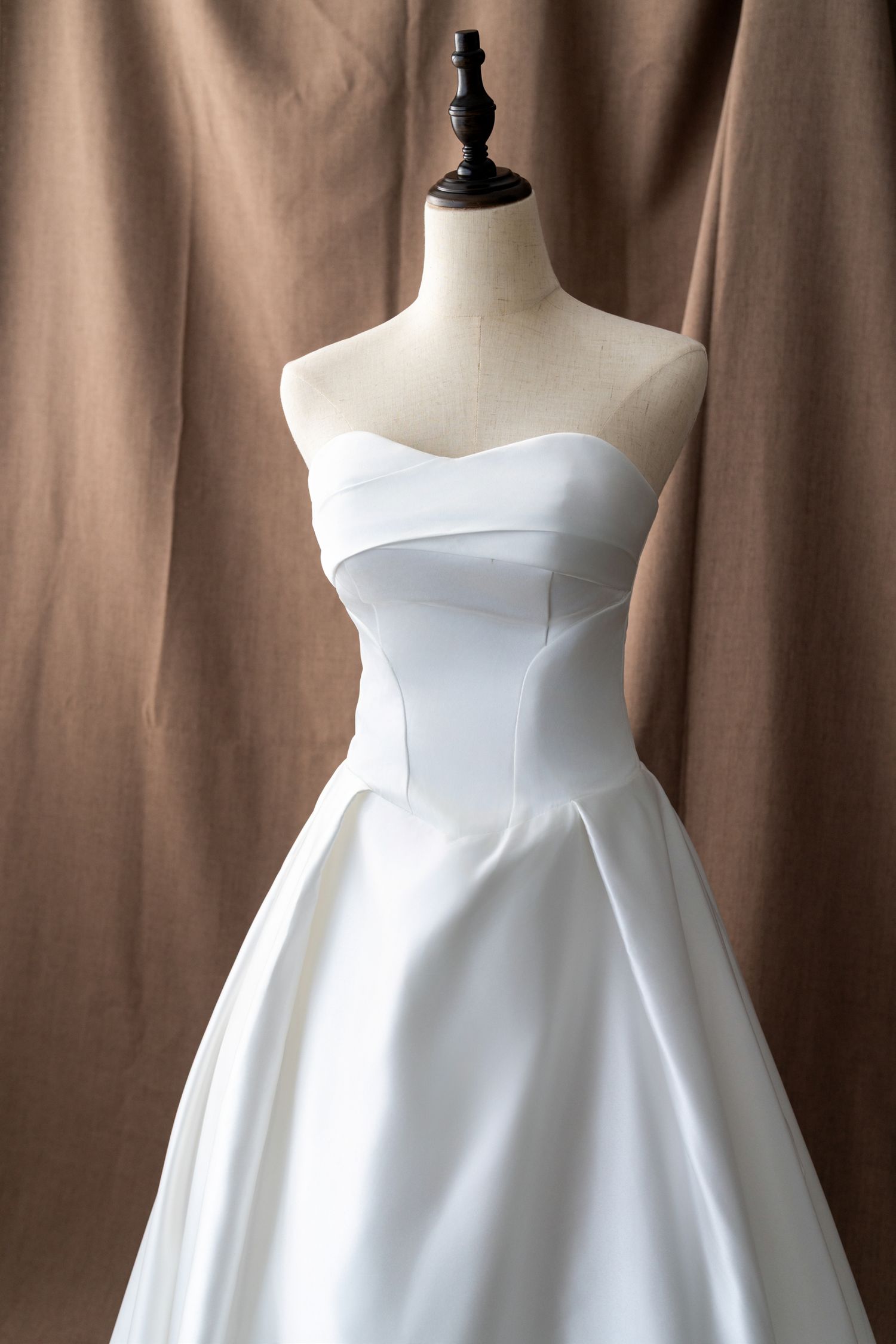 Classic white strapless wedding gown with structured bodice and full skirt.