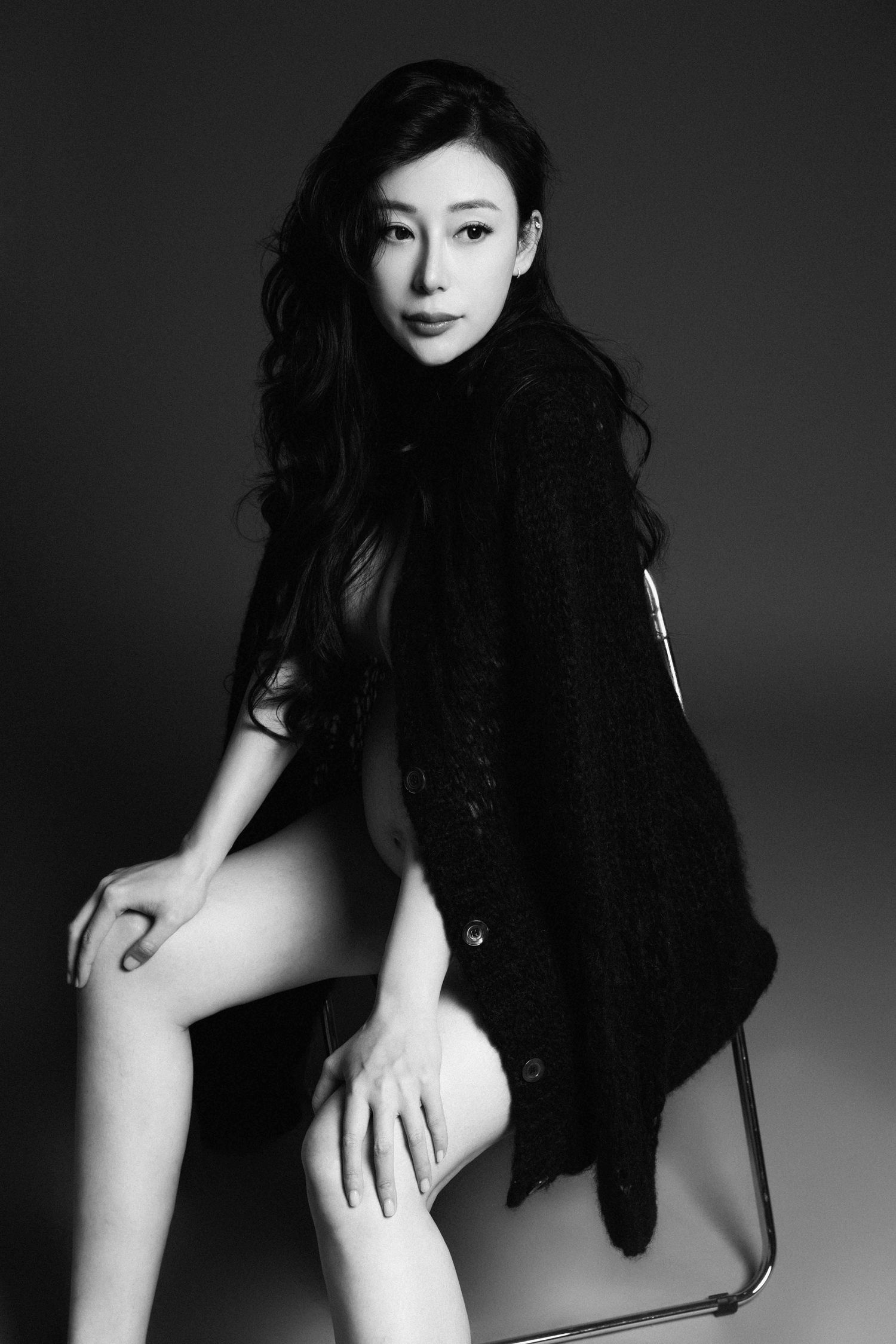 Dramatic black and white artistic portrait series with dark fabric.