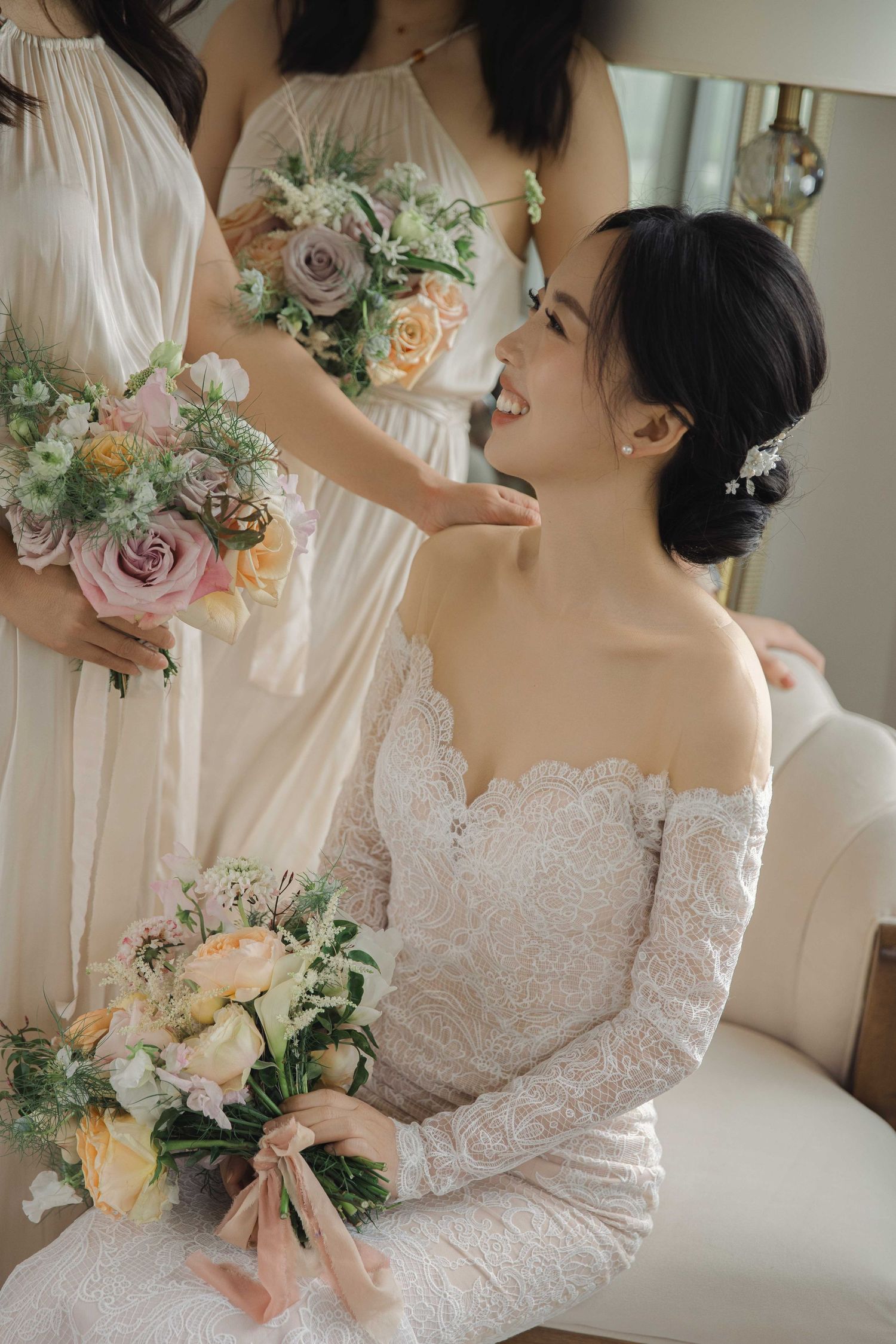 Collection of bridal portraits showcasing delicate pastel bouquets and lace wedding dress details.