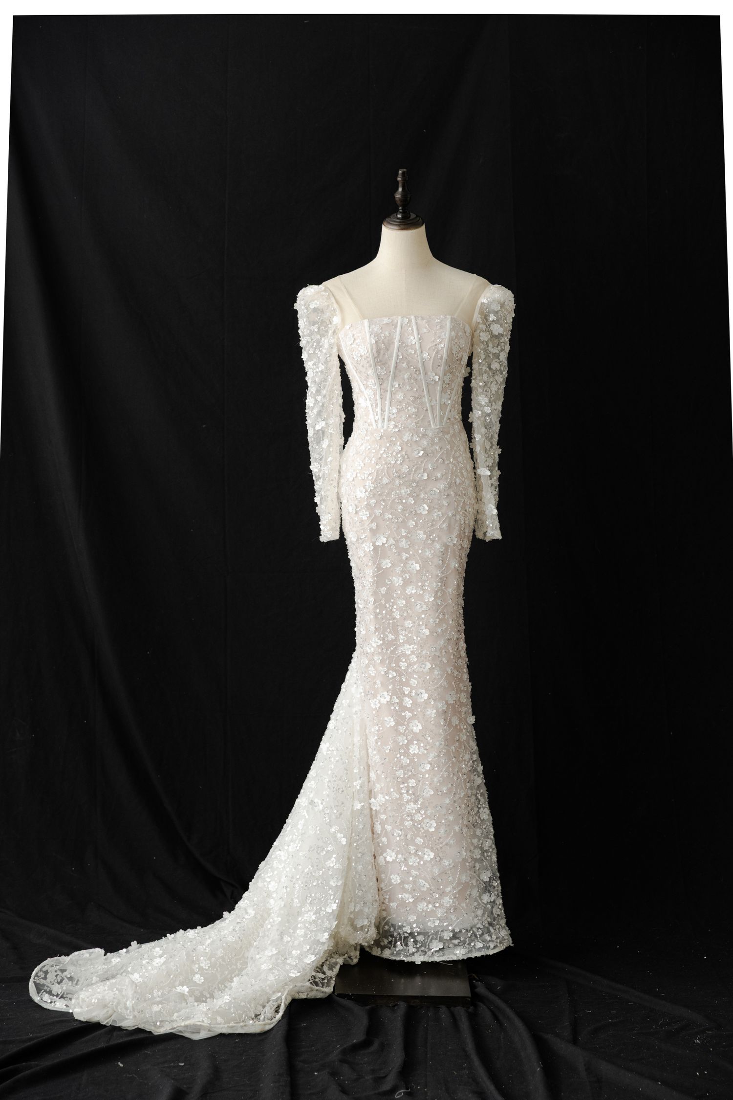 Elegant white lace wedding dress with long sleeves shown from different angles on a mannequin.