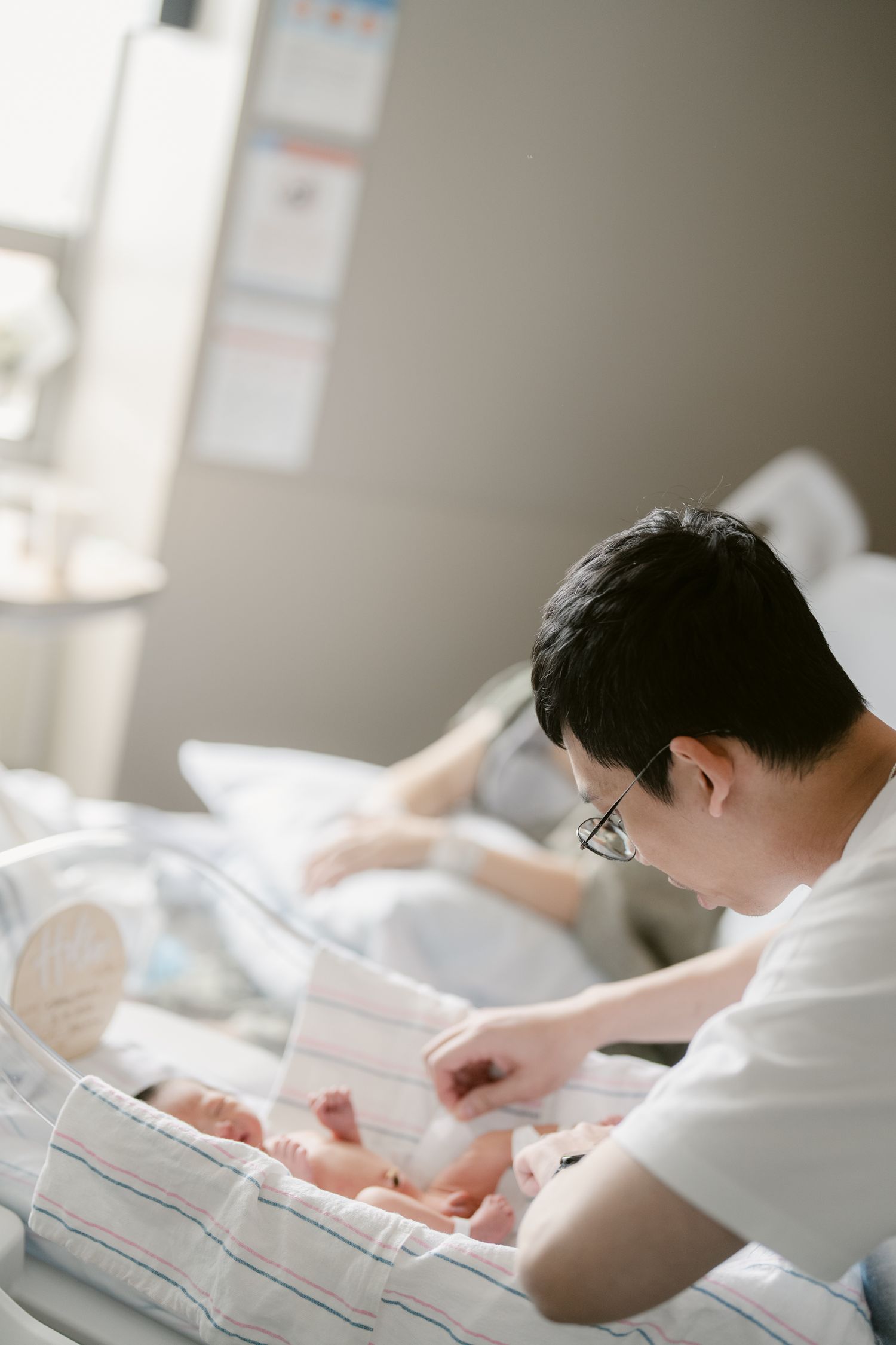 Medical professional tends to a newborn baby in a clinical environment.