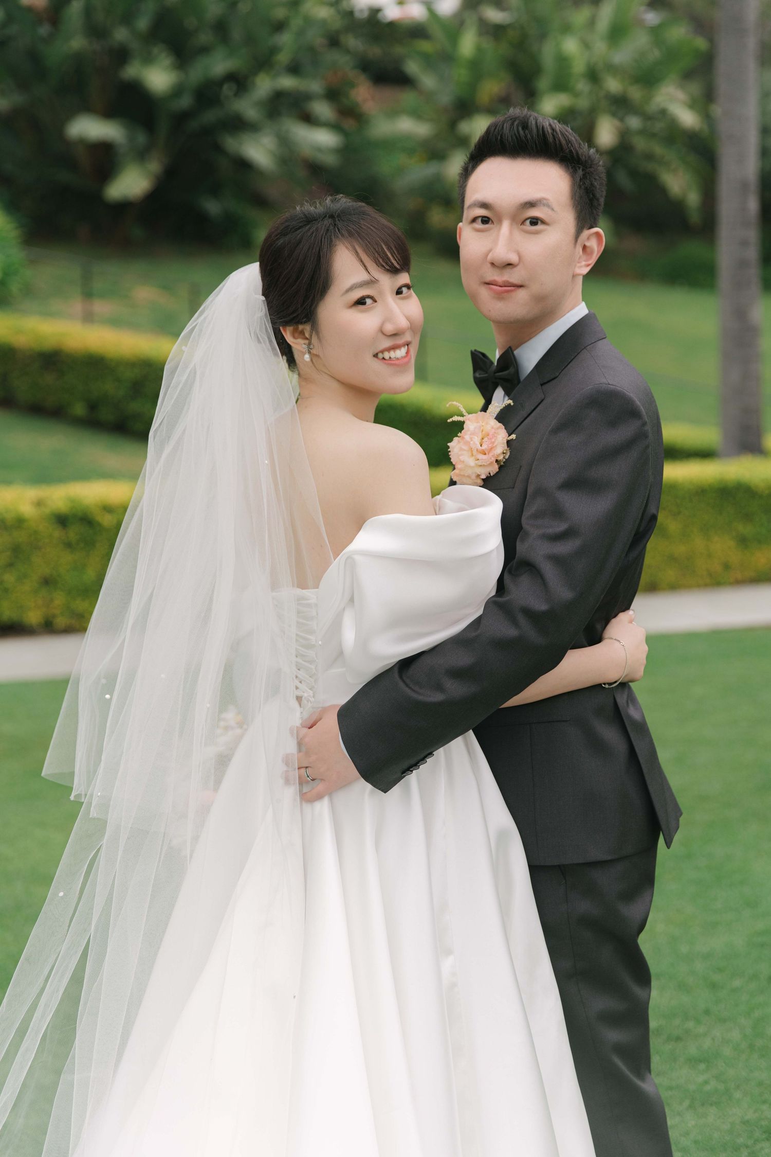 A romantic wedding portrait session in an outdoor garden setting.