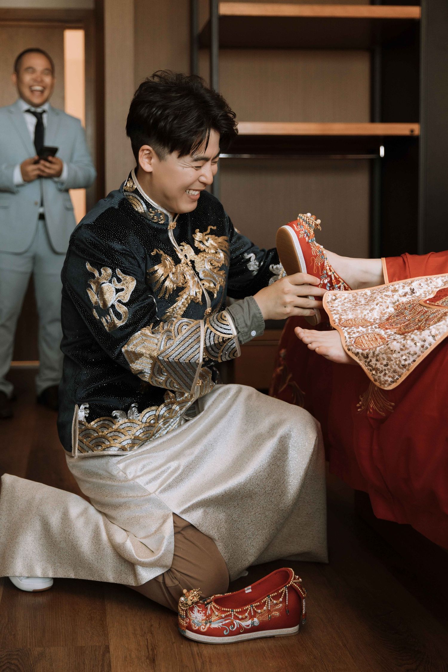 Person in traditional Chinese attire opening red envelopes during wedding celebration.