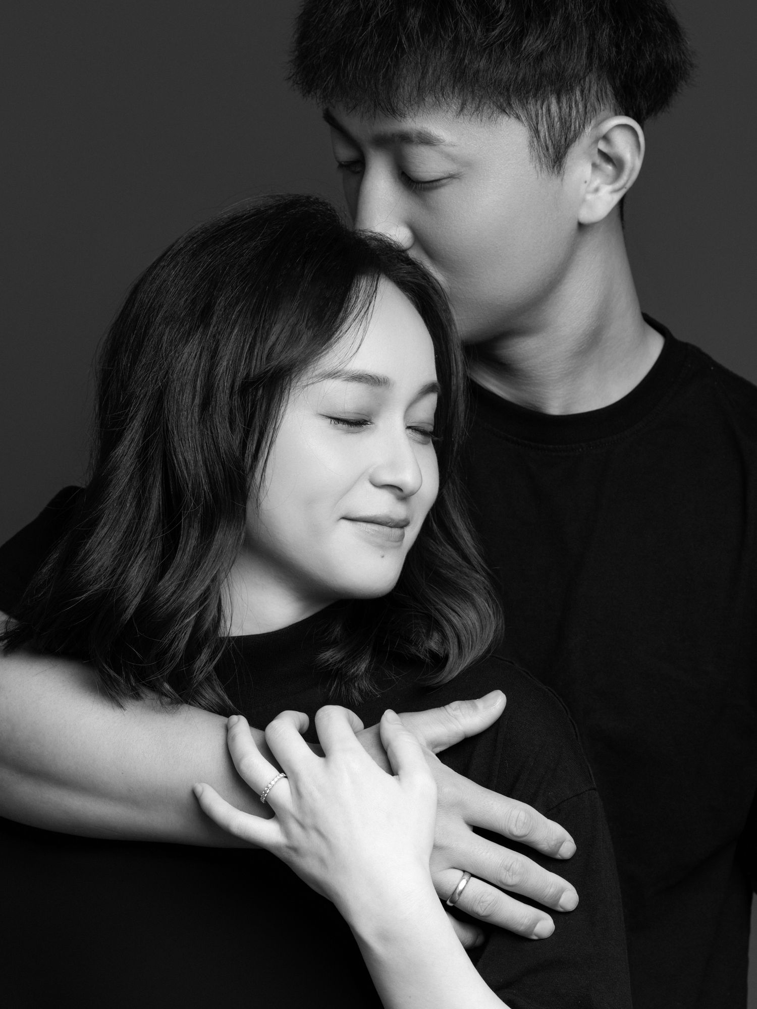 Artistic black and white photos capturing tender moments between a couple.