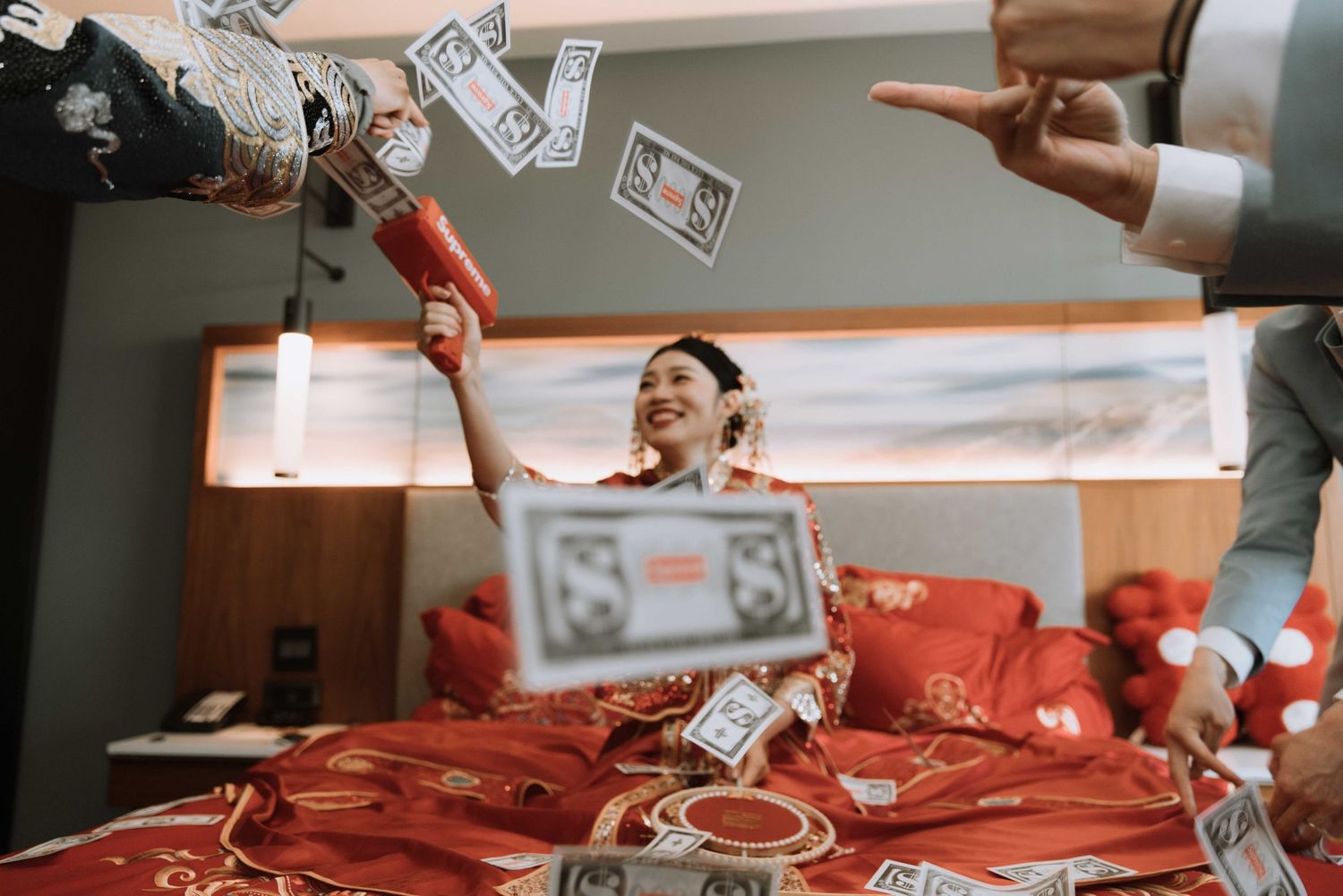 Money being thrown in celebration during traditional Chinese wedding festivities.