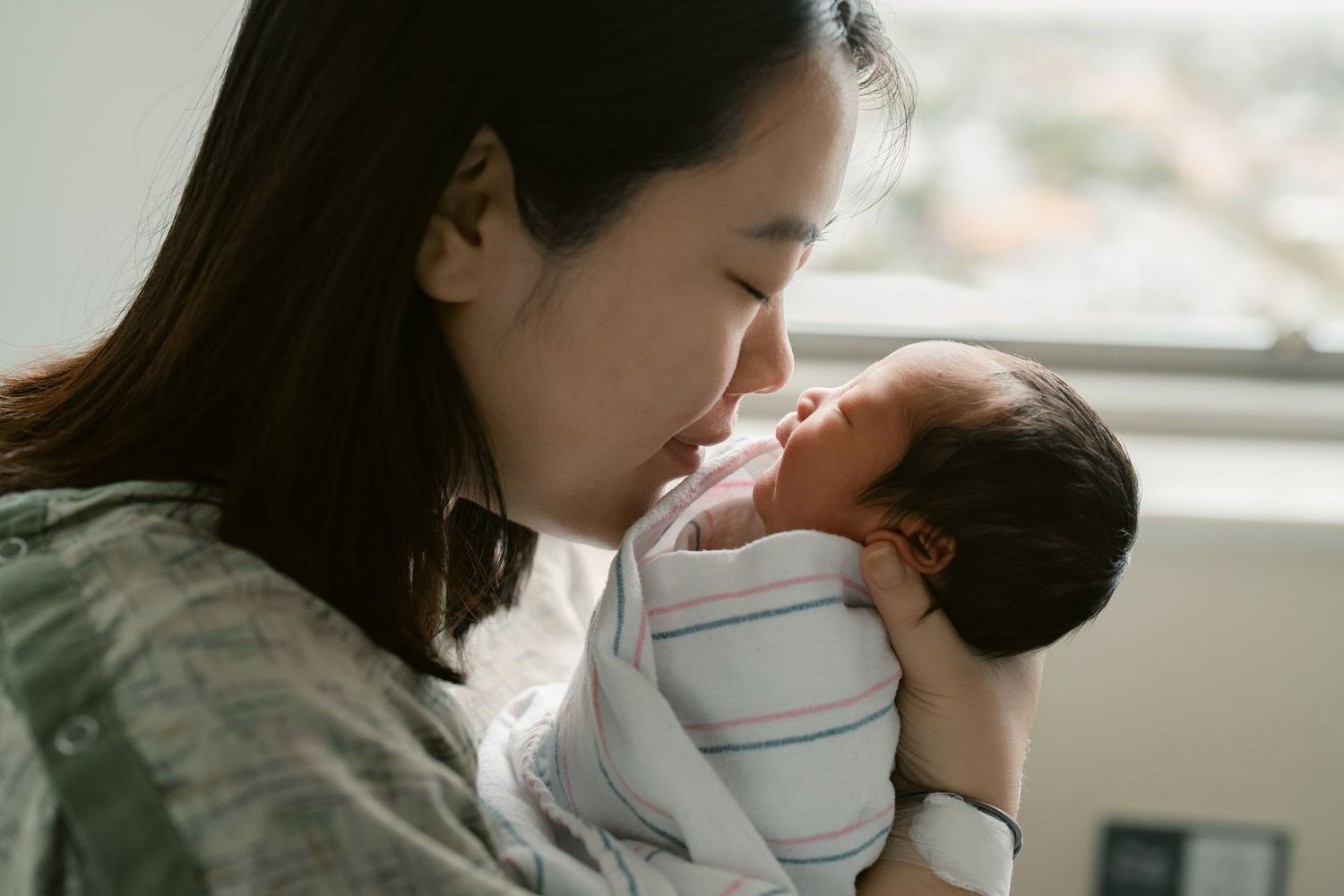 Intimate close-up shots of a mother bonding with her newborn baby.