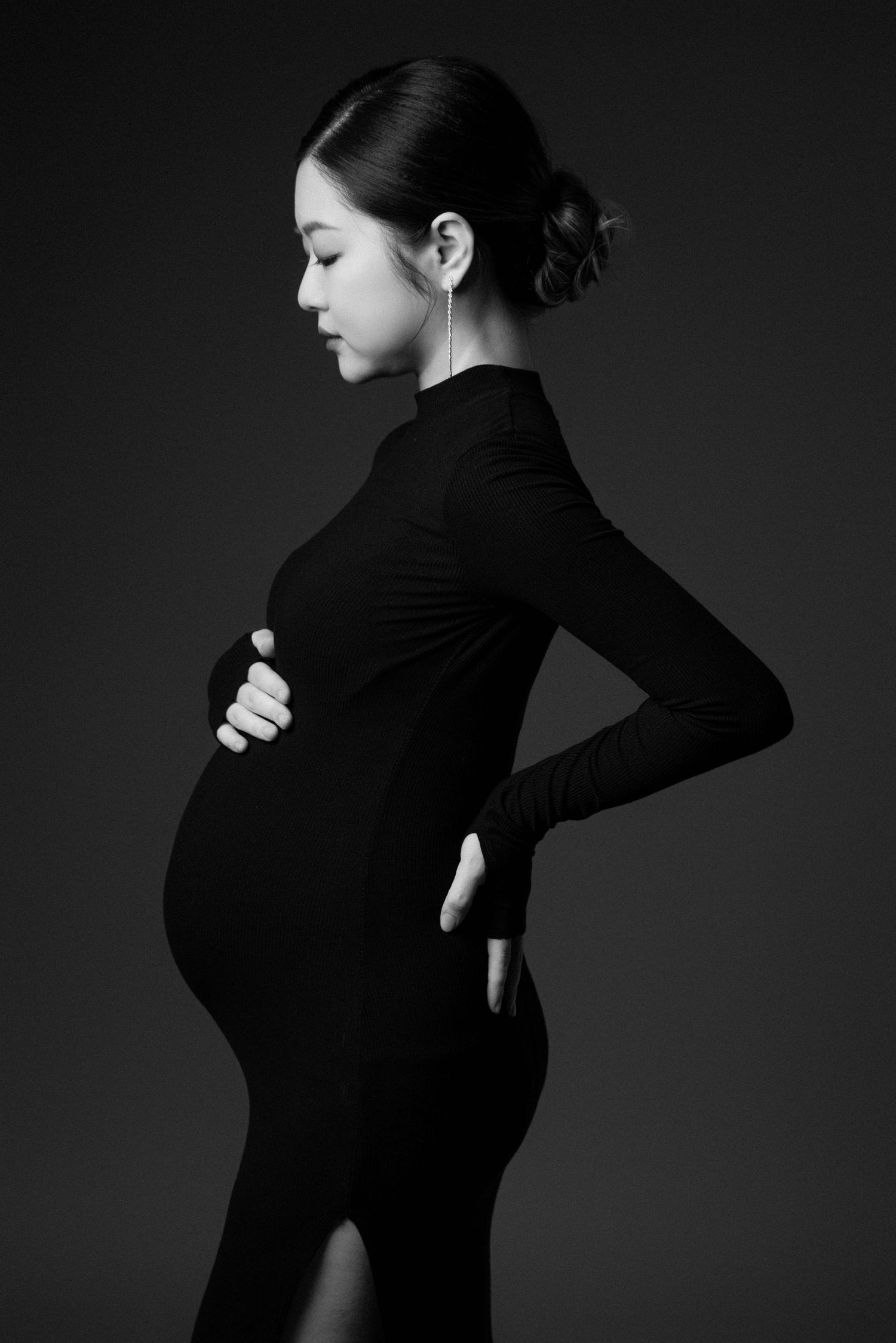 Artistic black and white maternity portraits showing profile poses in fitted clothing.