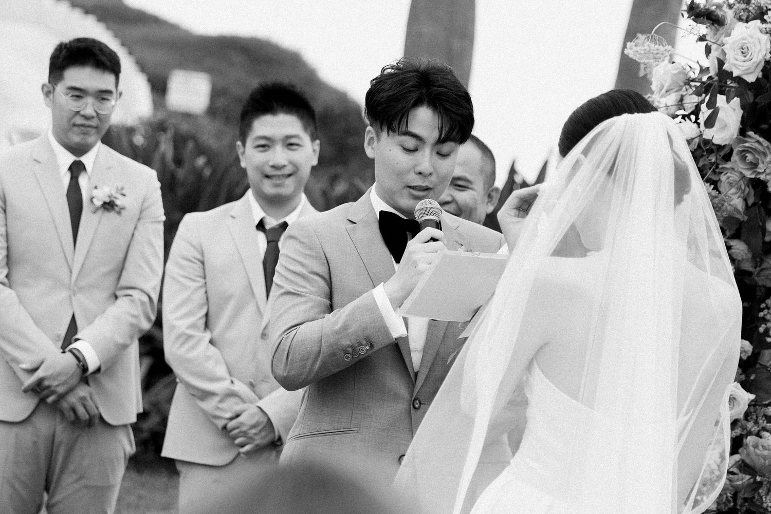 Black and white photo of emotional wedding ceremony moment.