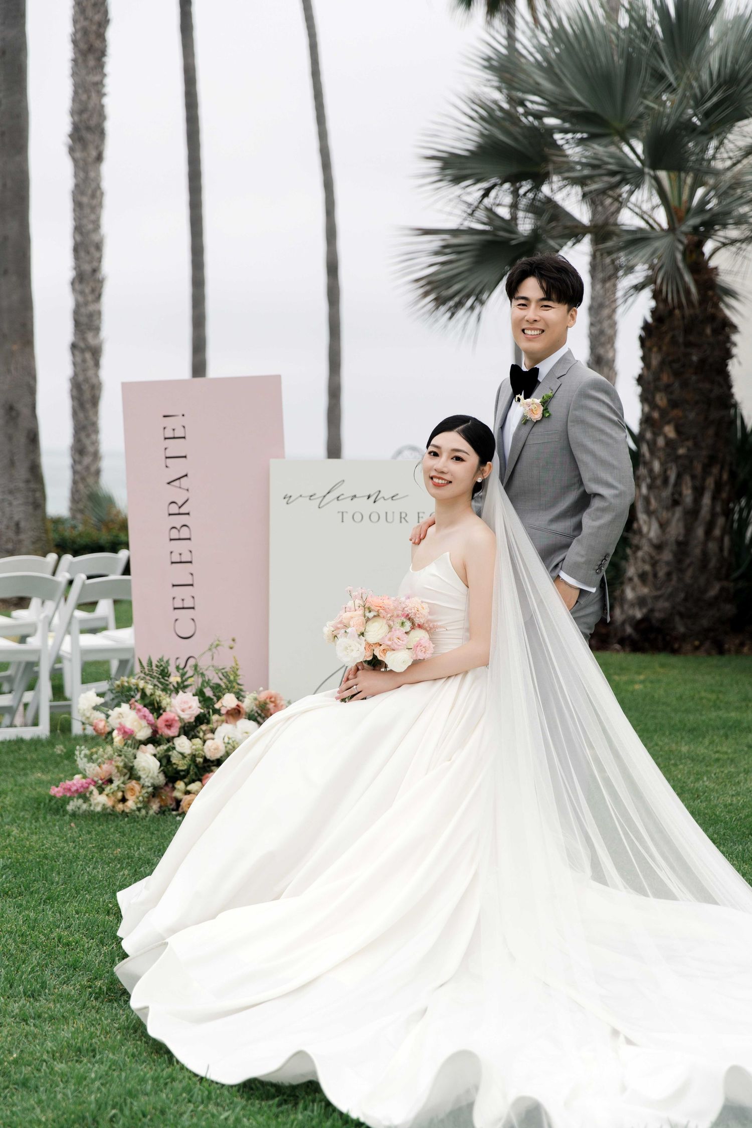 Outdoor wedding photos with pink signage and palm trees in the background.