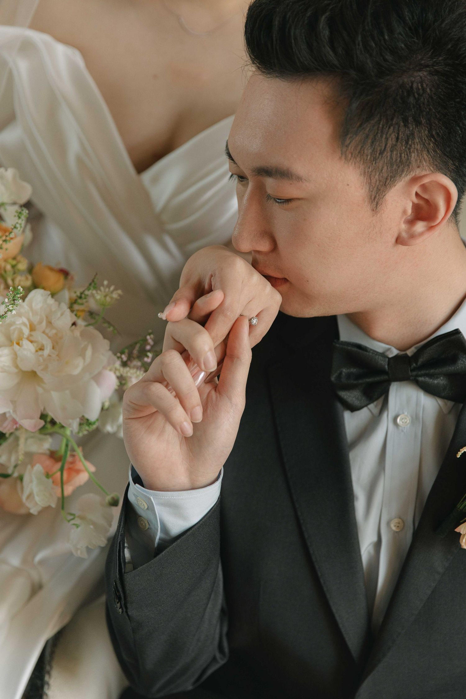 Intimate close-up shots of tender moments in formal wedding attire.
