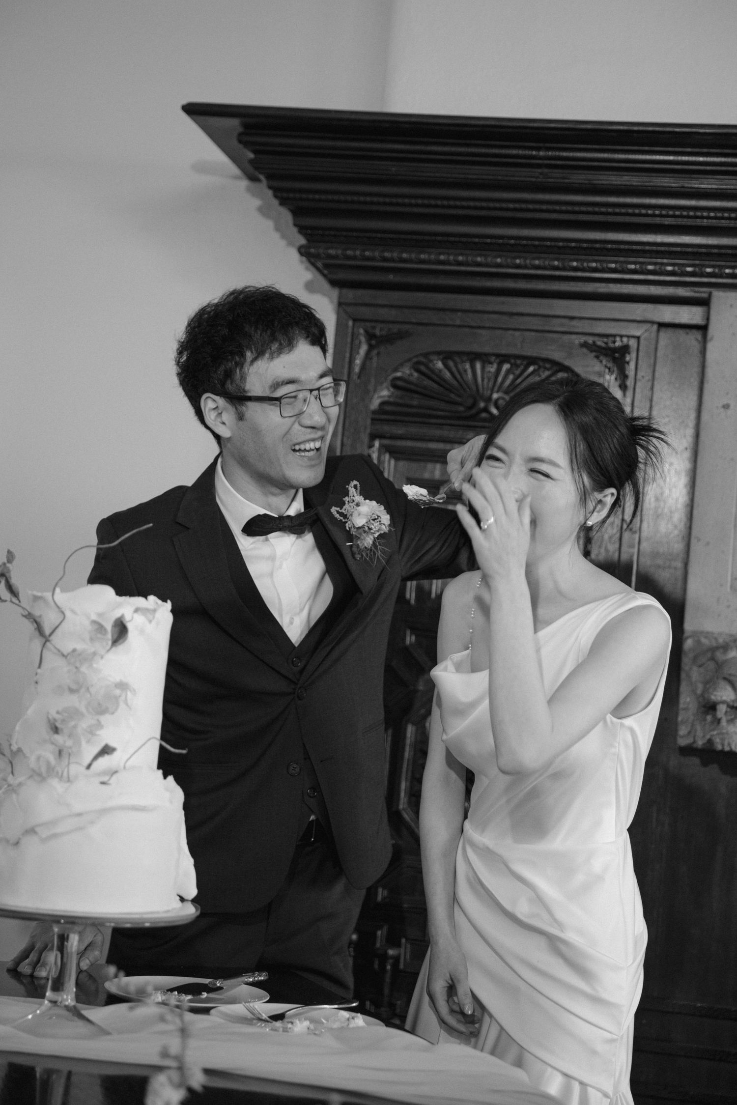 Candid moments of joy and laughter while cutting the wedding cake.