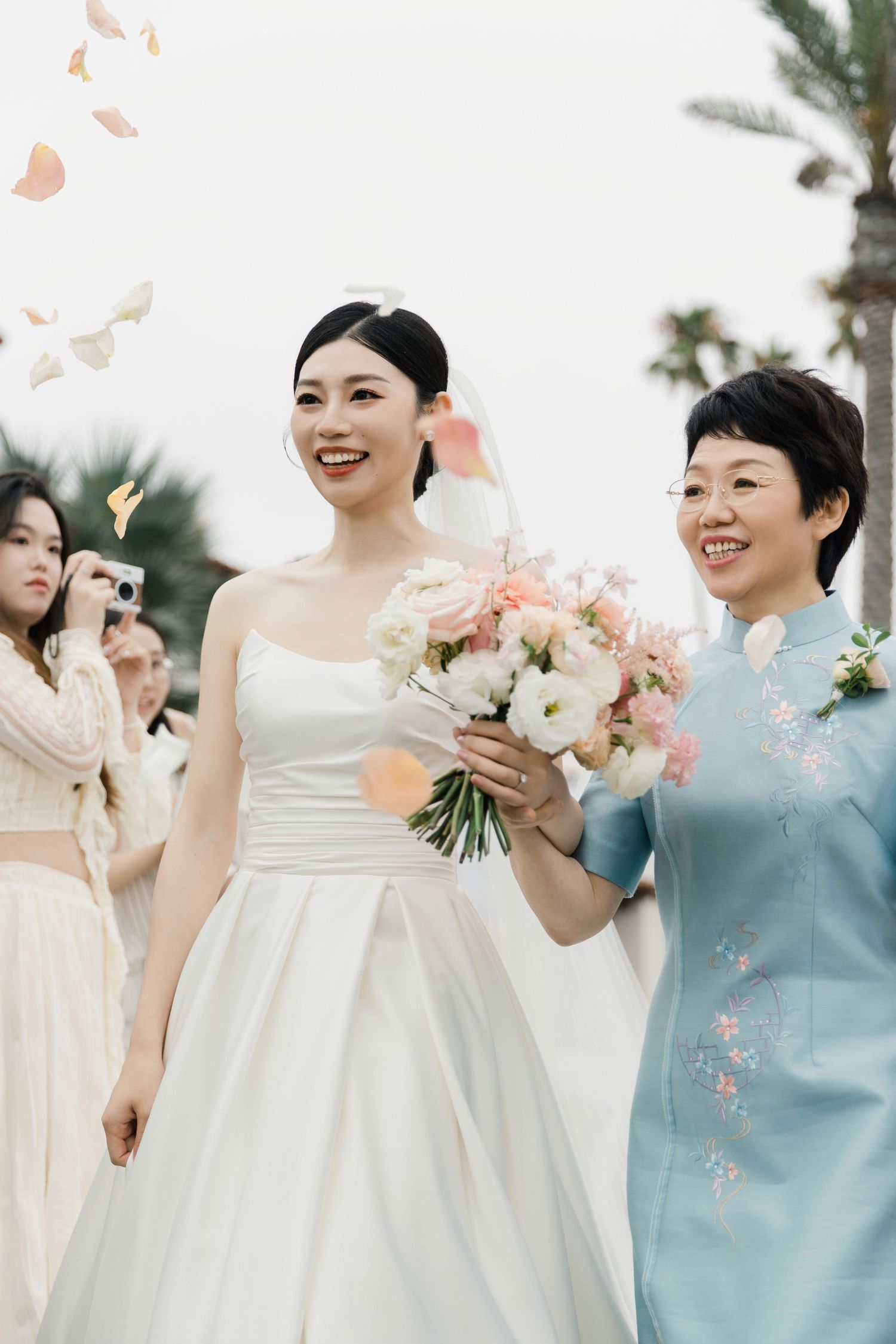 Wedding celebration with delicate butterflies floating in the air during an outdoor ceremony.