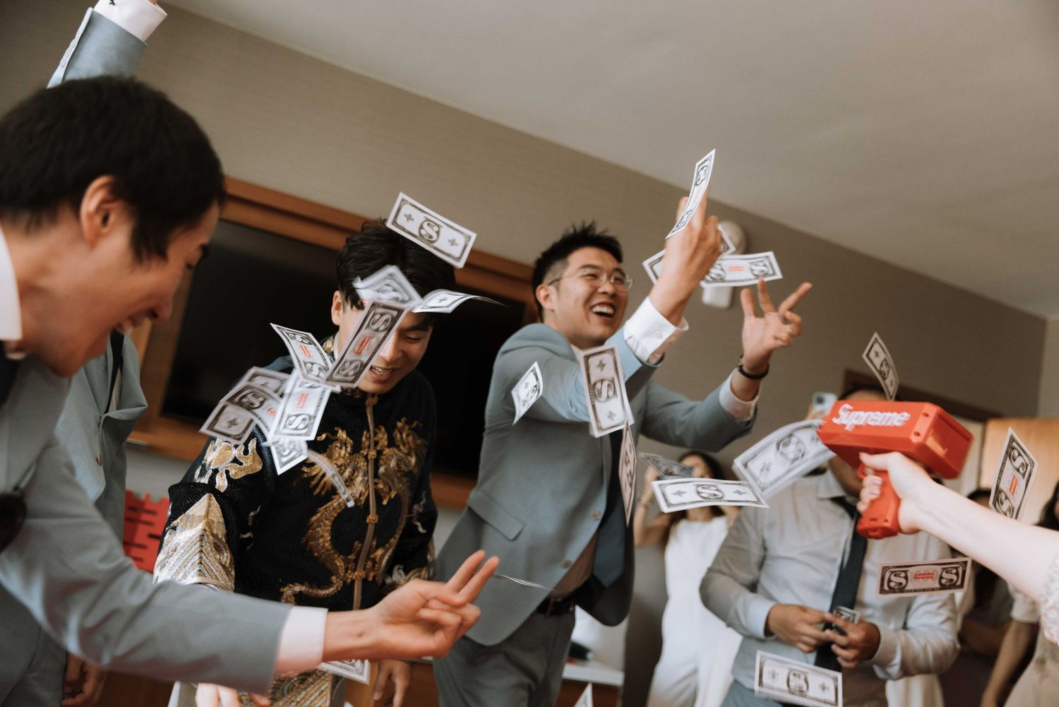 Joyful celebration with money being thrown in the air during wedding festivities.