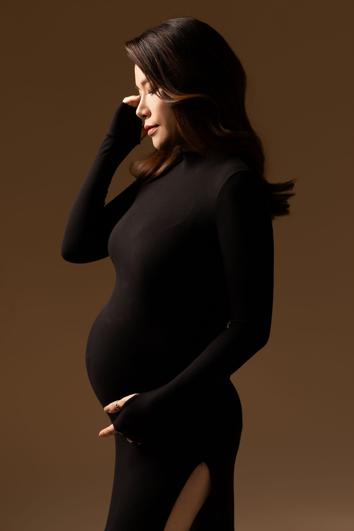 Artistic portrait series in black attire against dramatic brown backdrop.