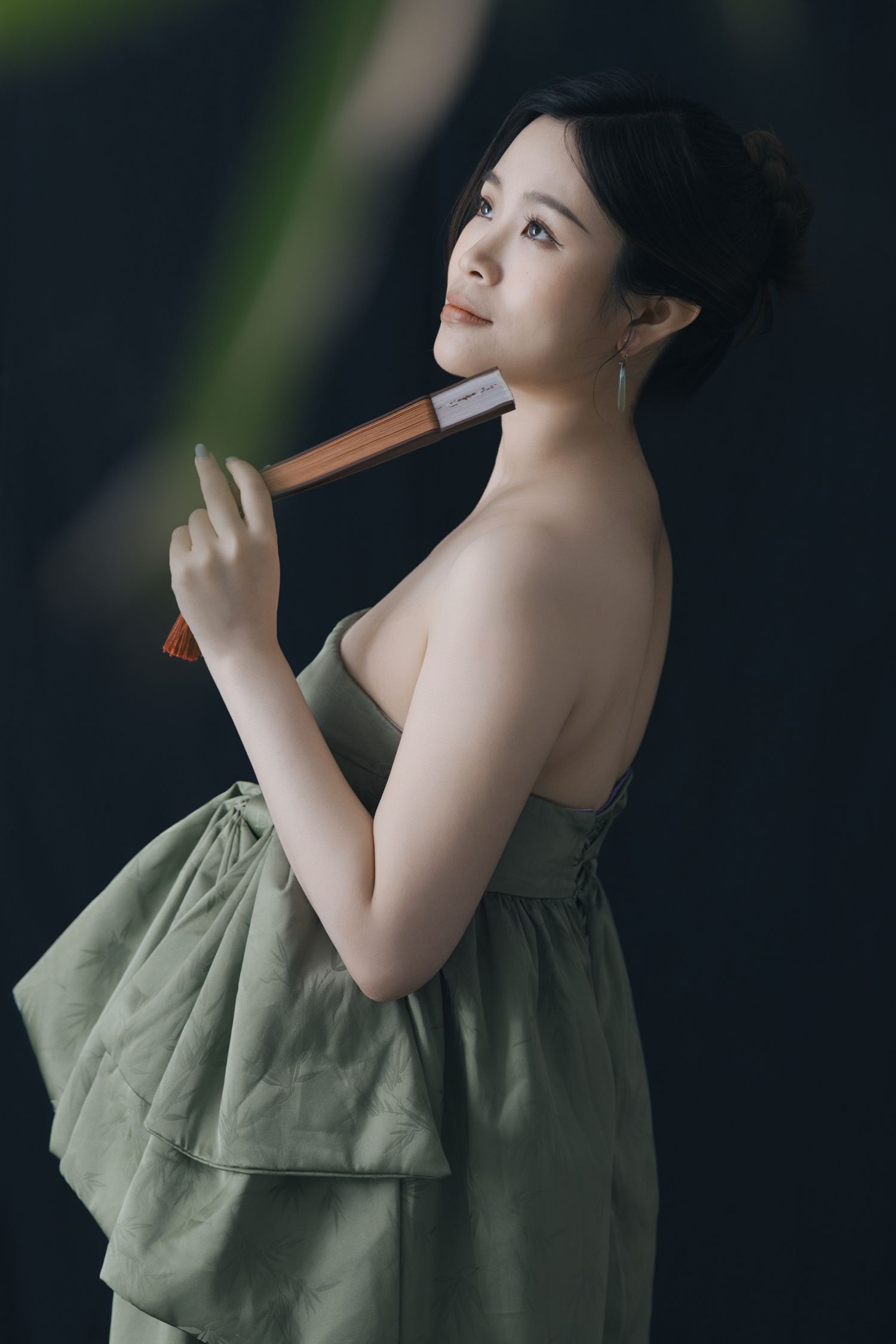 Artistic maternity portrait series with popsicle and green strapless dress.