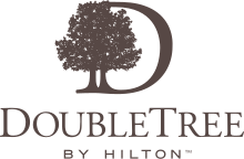 Silhouette of trees forming part of a company logo design in dark brown.