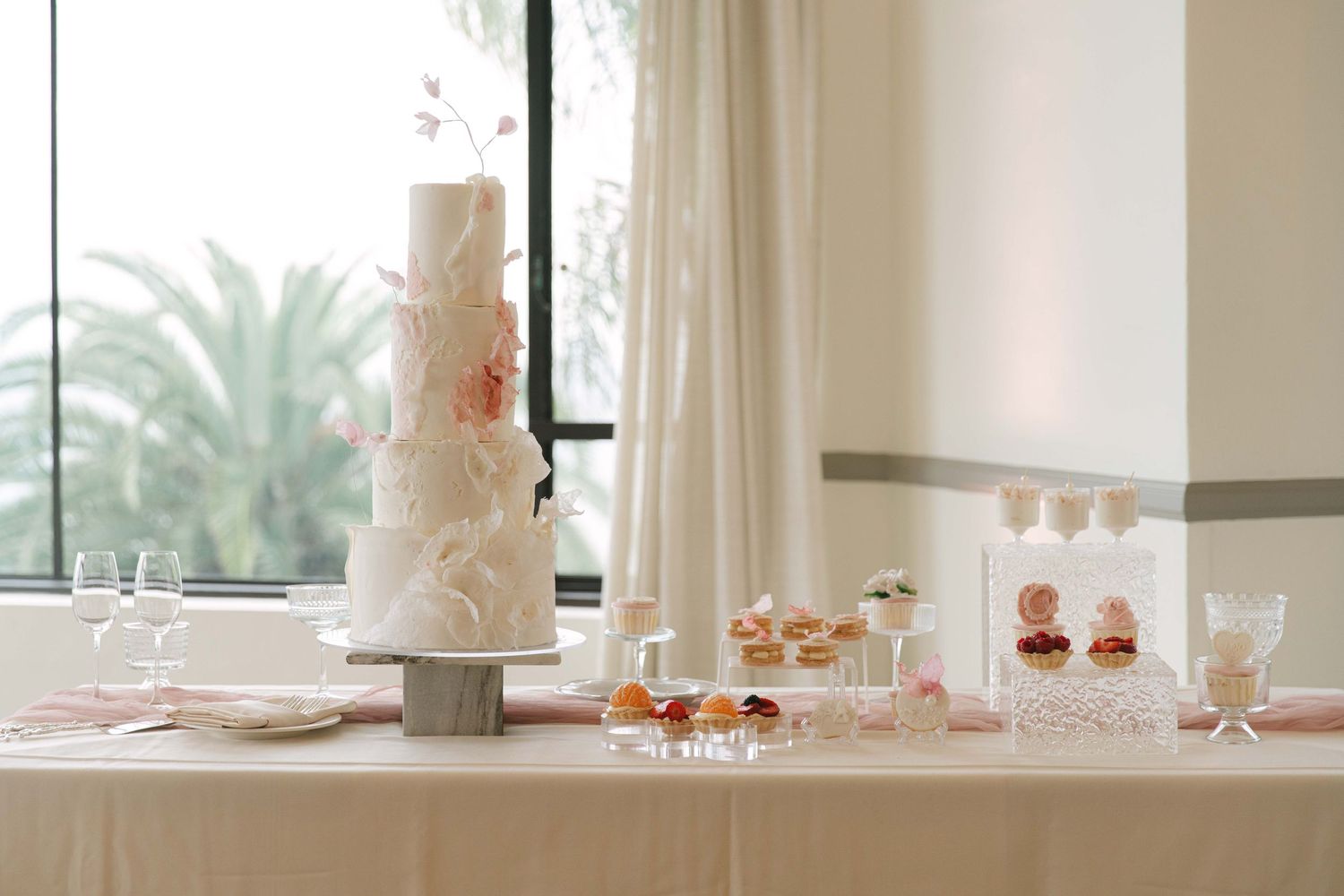Bright wedding venue interior with white walls and elegant table settings.