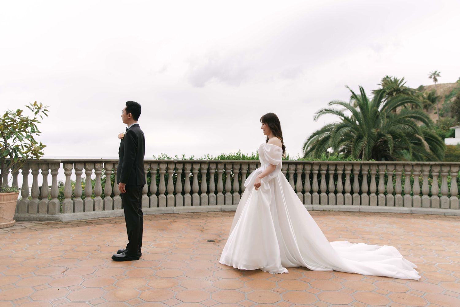 Panoramic wedding photo series on a terrace with palm trees and balustrade.