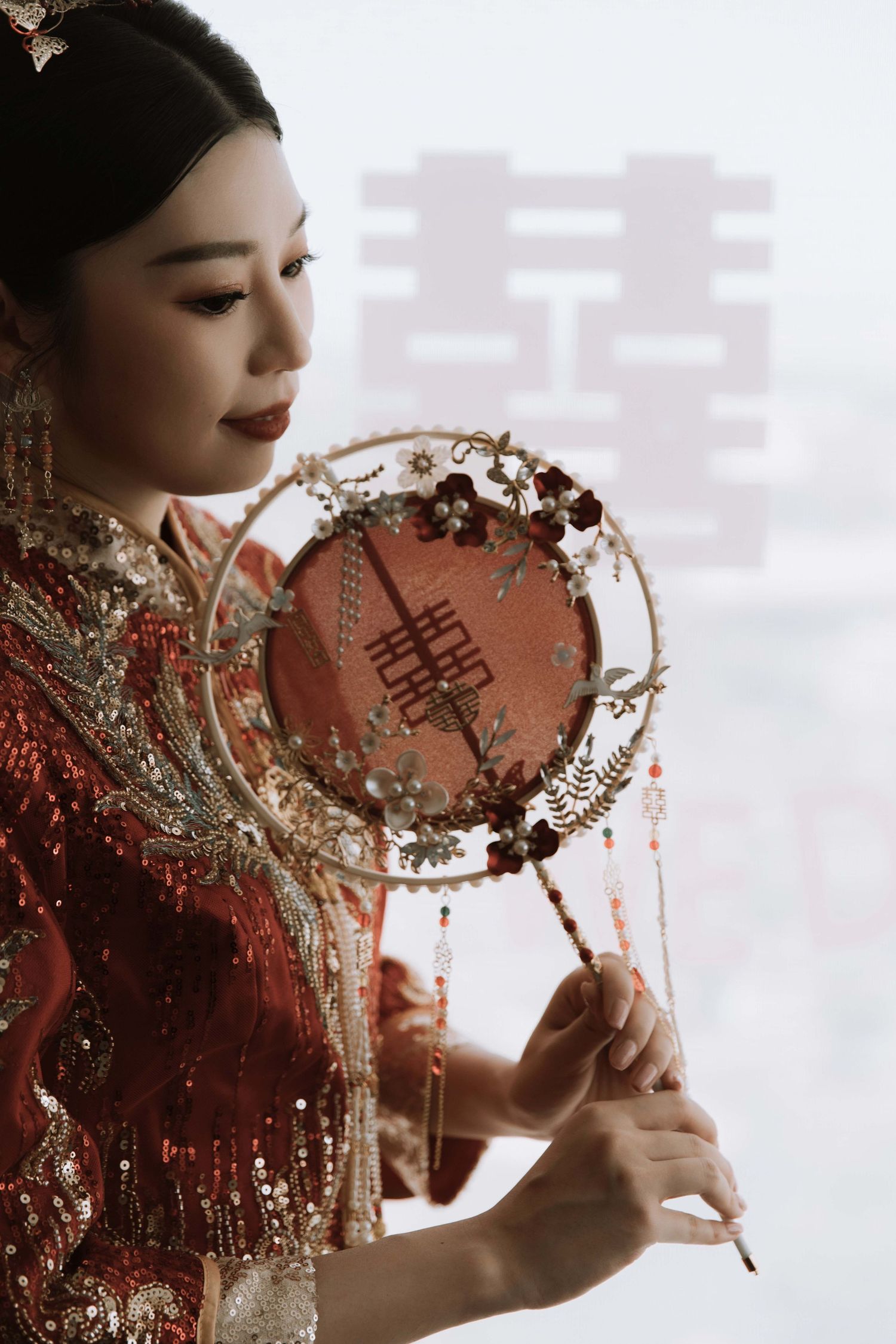 Traditional Chinese wedding details with gold embellishments and red attire.